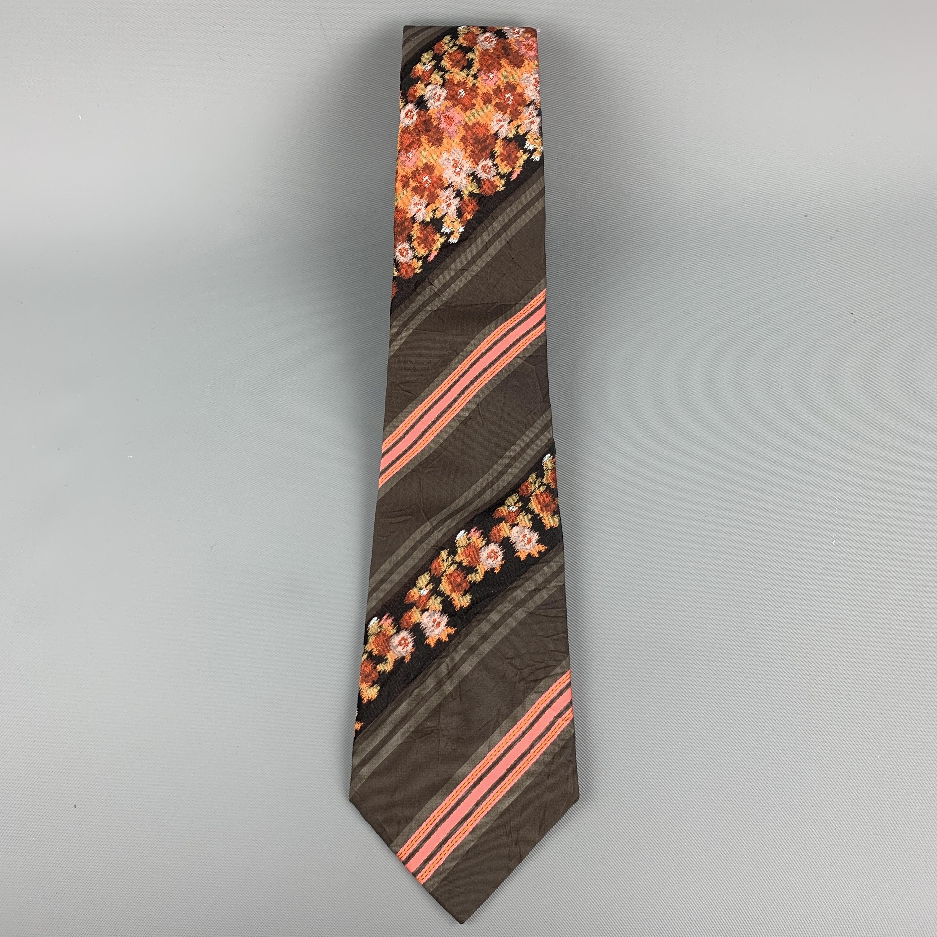 KENZO HOMME necktie comes in brown textured silk with all over pink and black floral diagonal stripe print. Made in USA.

Excellent Pre-Owned Condition. 

Width: 3.5 in.