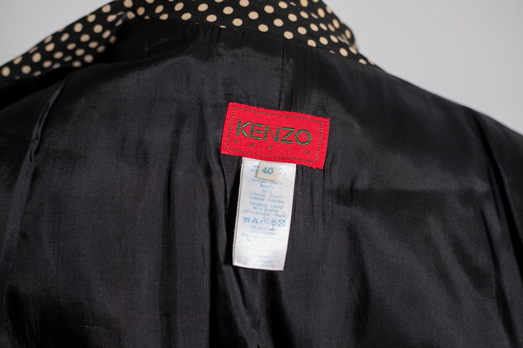 Shiny elegant polka-dot blazer by Kenzo from the 1980s, made in France. ORIGINAL LABELS.
The blazer has the classic elegant straight cut, down to the hips.
It has long delicate sleeves adorned with three black buttons. The collar has the classic