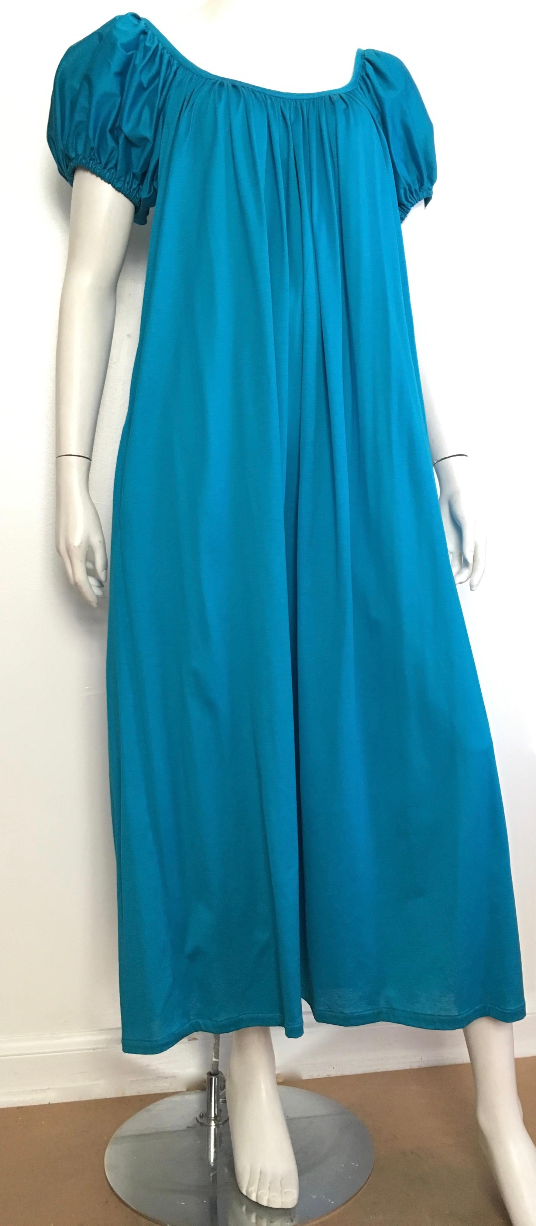 Kenzo Paris cotton maxi blue dress with pockets is a French size 40 and fits a 8.  Made in France.
Belt this dress, as shown in photo, and I think a size 6 could wear this dress but you be the judge.  Perfect dress for walking on the beaches in