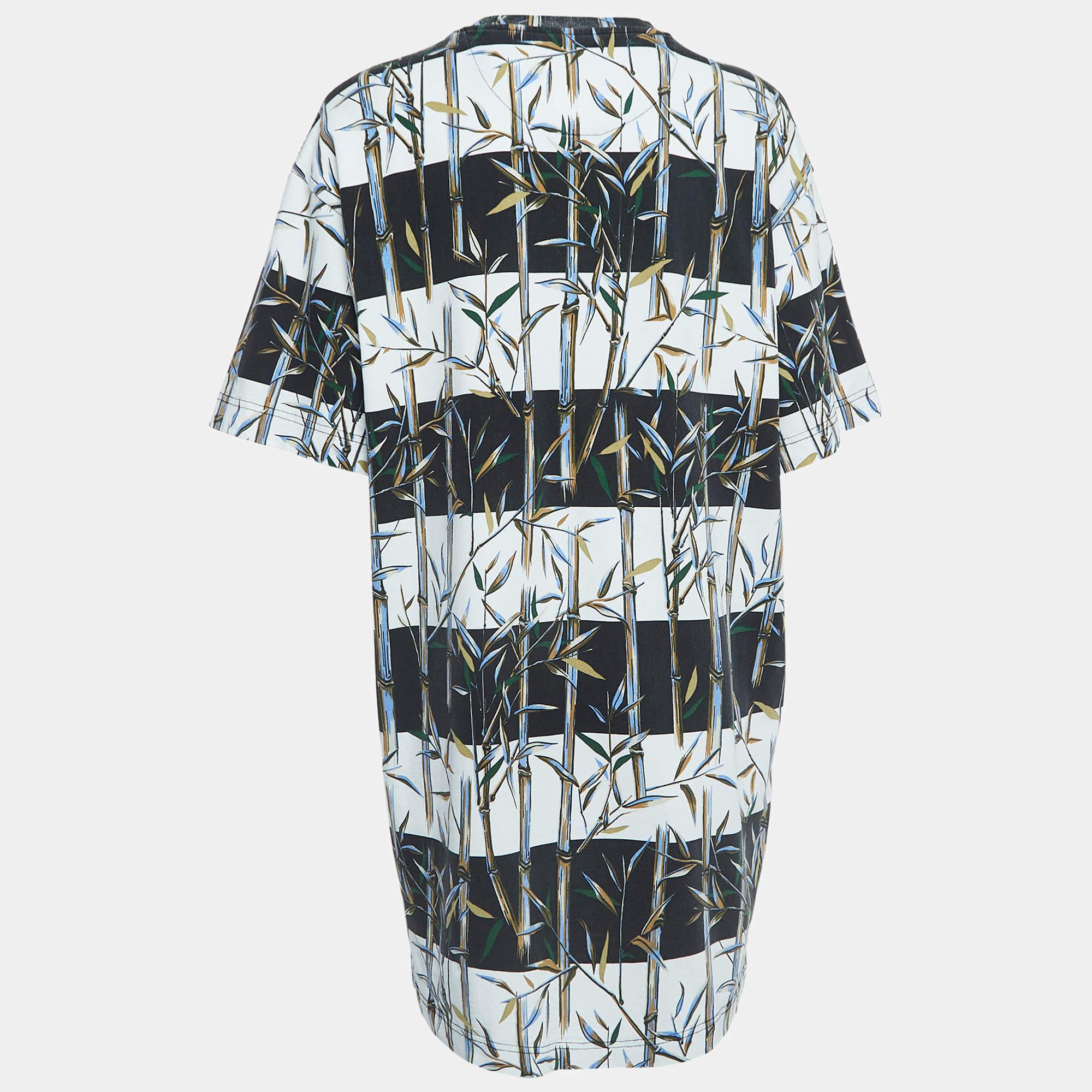 The Kenzo Memento Collection 2 t shirt dress is a vibrant and playful garment featuring a distinctive bamboo print. Crafted from high quality cotton it combines comfort with avant garde design making it a stylish and statement worthy addition to any