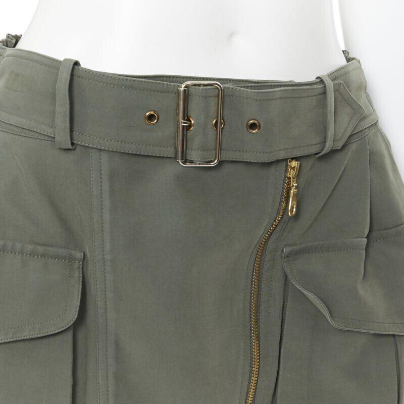 KENZO military khaki green cotton dual pockets belted elasticated skirt Fr38
Reference: CEWG/A00029
Brand: Kenzo
Model: Military skirt

Material: Cotton
Color: Green
Pattern: Solid
Closure: Zip
Lining: Viscose
Extra Details: Attached belt