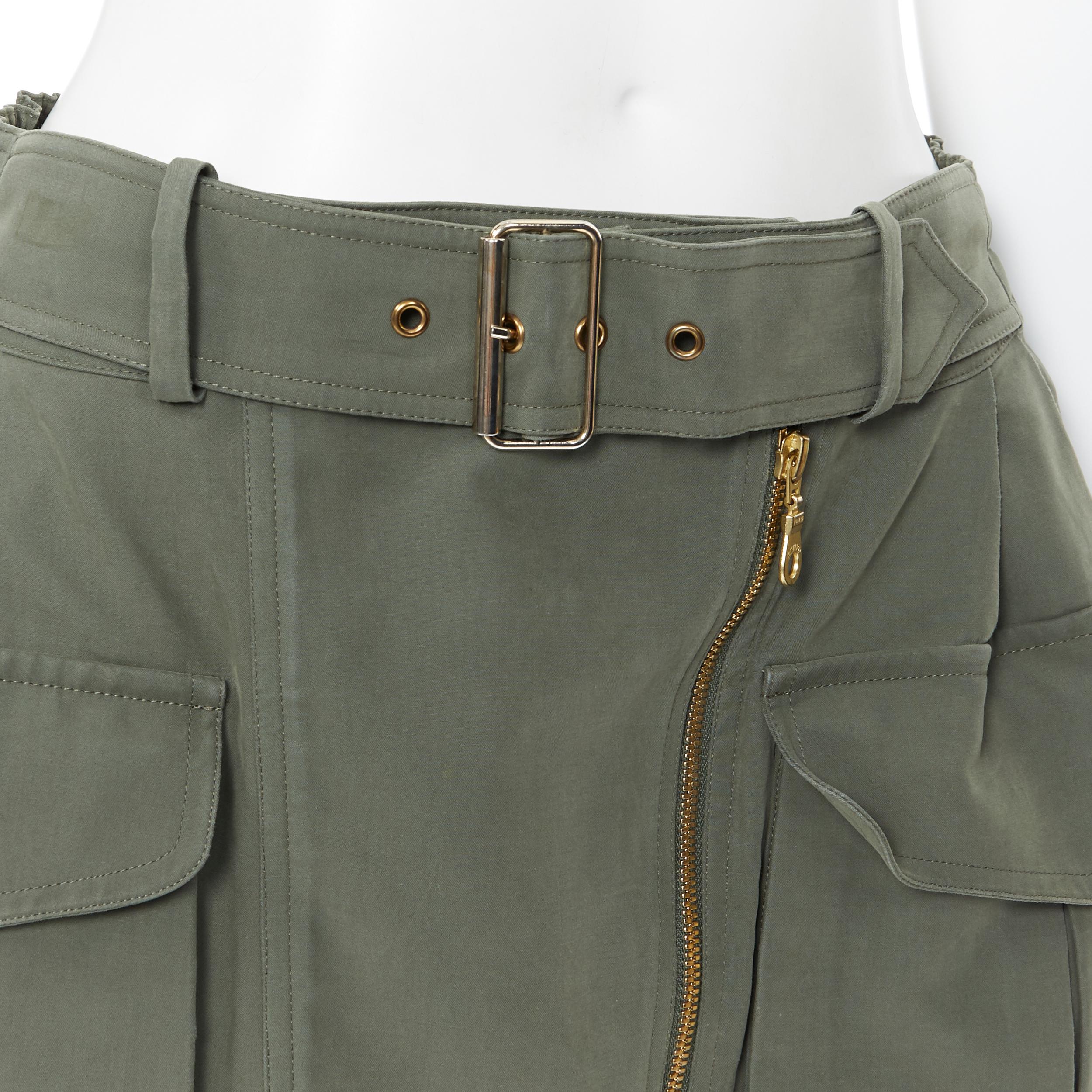 KENZO military khaki green cotton dual pockets belted elasticated skirt Fr38
Brand: Kenzo
Extra Detail: Attached belt design.

CONDITION:
Condition: Good, this item was pre-owned and is in good condition. 
Please refer to image gallery for thorough
