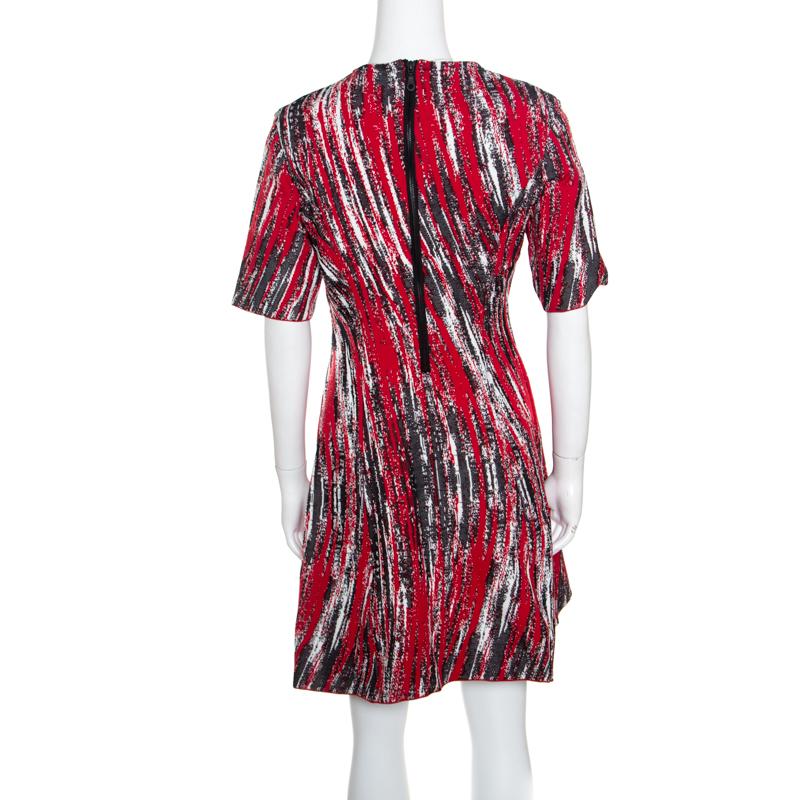 Fashioned to make you look elegant and stylish, this dress from Kenzo's Spring 2014 collection has been designed with jacquard knitting, short sleeves and a curved overlap bodice detail. You can wear this creation with a pair of slingback