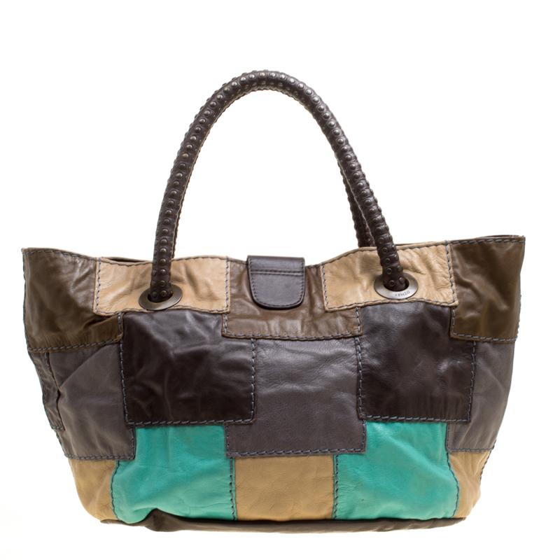 Designed in a subtly slouchy silhouette, this pretty hobo from the house of Kenzo features a multicoloured leather body adorned with an interesting patchwork design and secured with a small, logo engraved flap on the top. It comes fitted with two