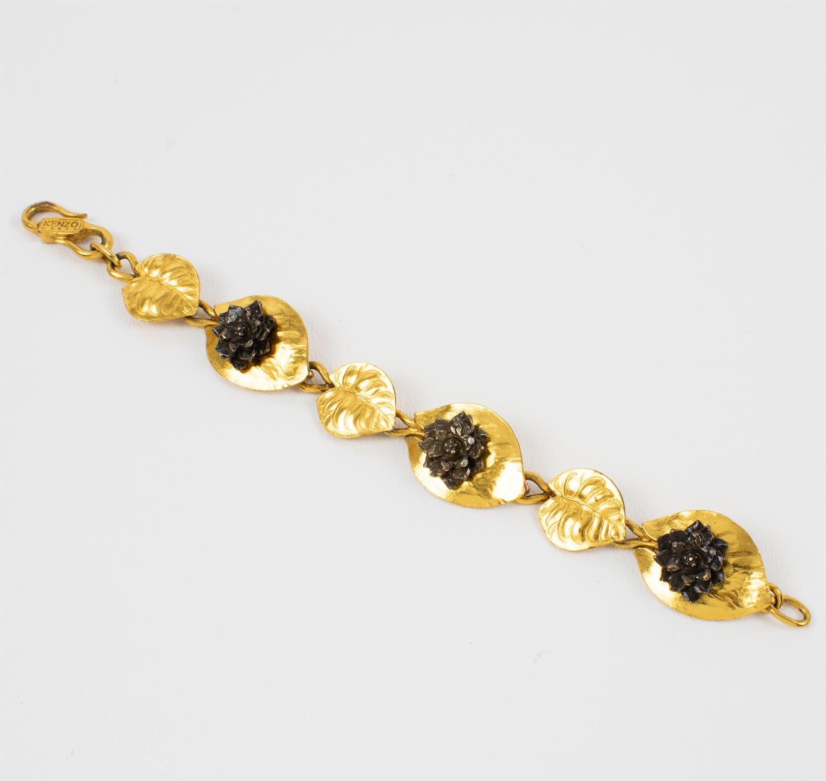 This charming Kenzo Paris floral link bracelet features gilded metal and bronze, all carved and textured water lily flowers and leaves. The bracelet closes with an 