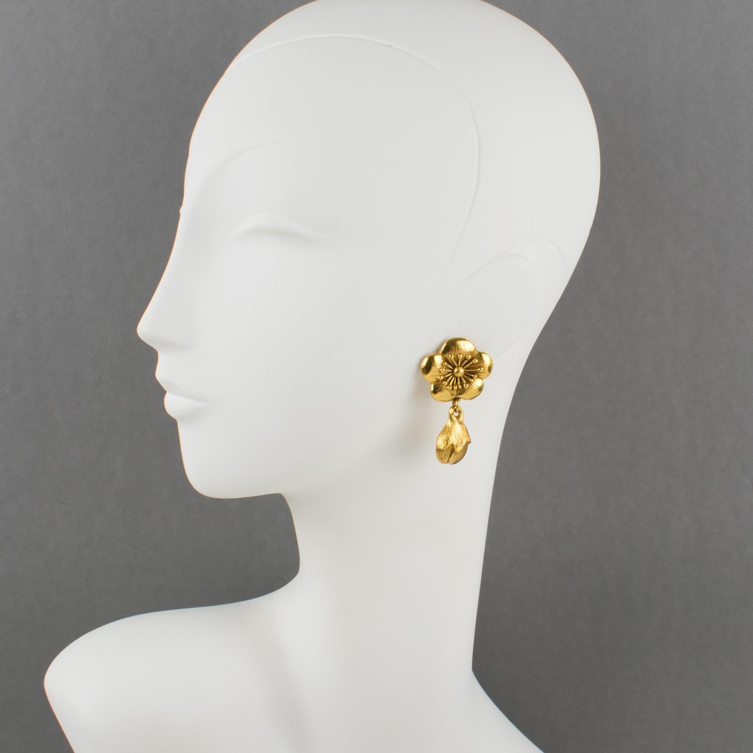 These lovely Kenzo Paris floral clip-on earrings feature a dangling drop shape with gilt metal, all carved and textured. The design is cherry blossom flowers and buds. Marked underside 