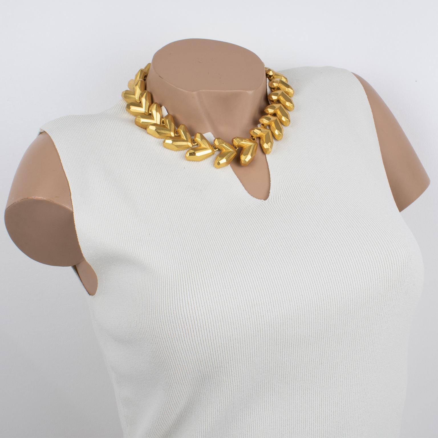 This gorgeous Kenzo Paris choker necklace features an around-the-neck geometric shape with gilt metal dimensional carving and satin finish textured aspect. The brand tag 