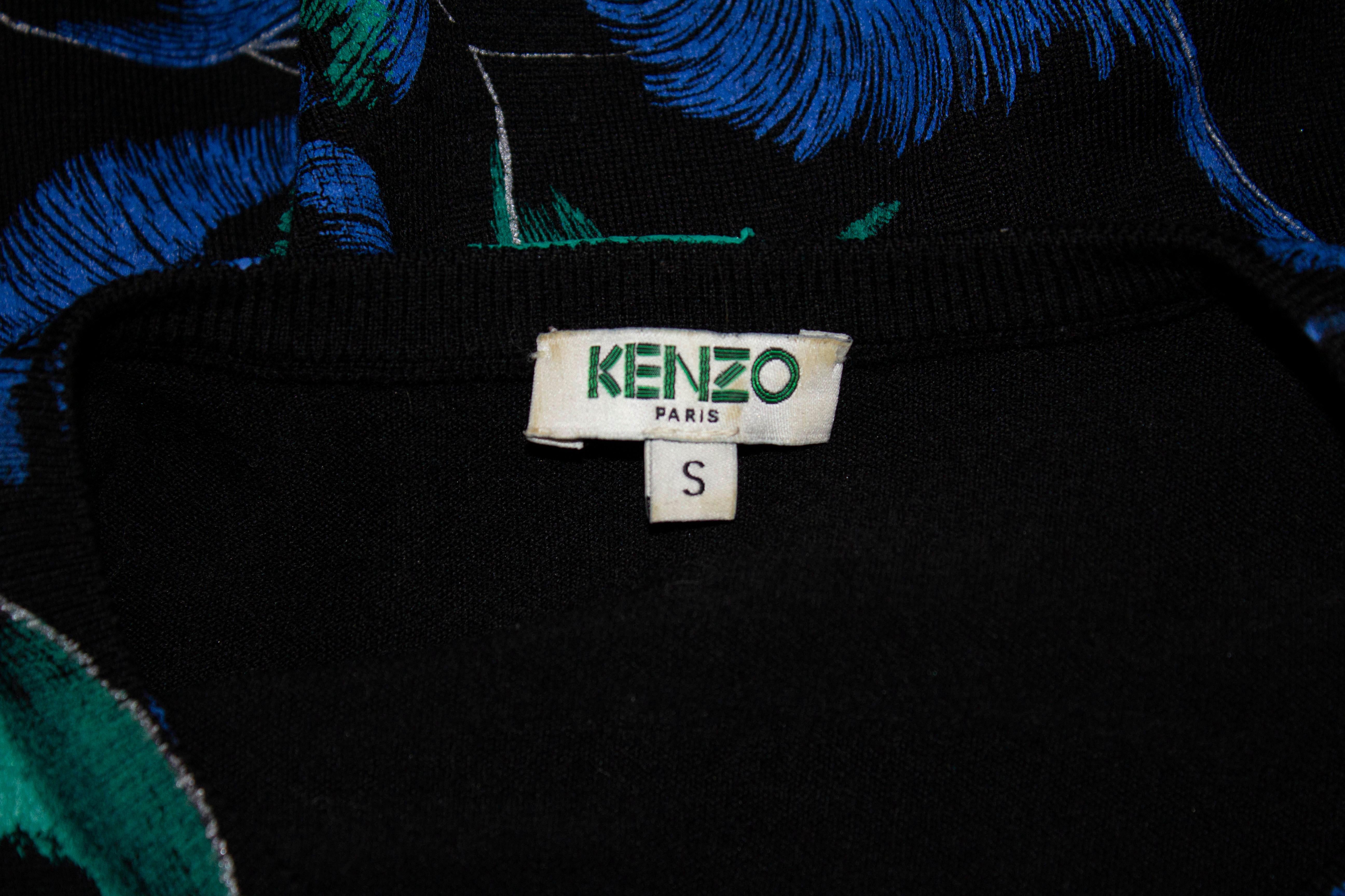 A fun dress for Spring /Summer by Kenzo Paris.  This knitted dress, in a wool mix has a black background with a blue and green print . It has short sleaves and a flared skirt. 
Measurements: Bust 34'', length 35''