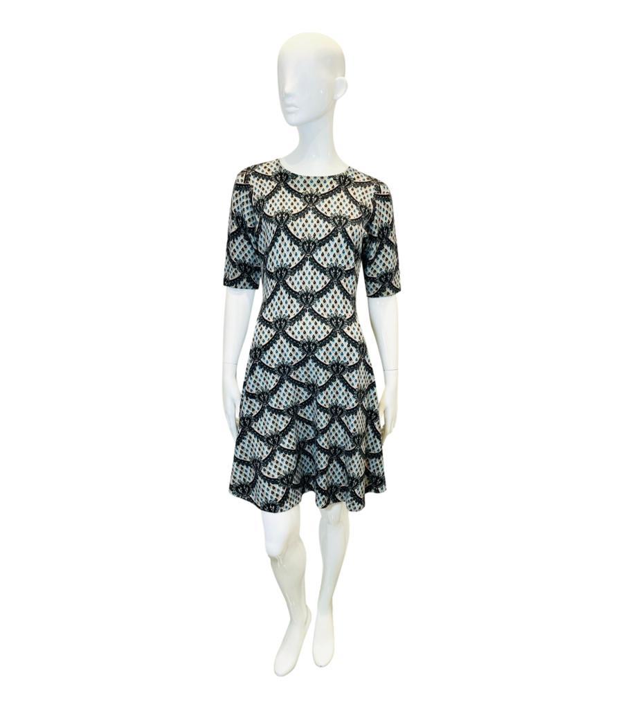 Kenzo Printed Wool Dress
Light grey and blue skater dress designed with black decorative print with signature 'Eye' motif throughout.
Featuring round neckline, above-the-elbow sleeves and flared A-Line skirt.
Size – M
Condition – Very