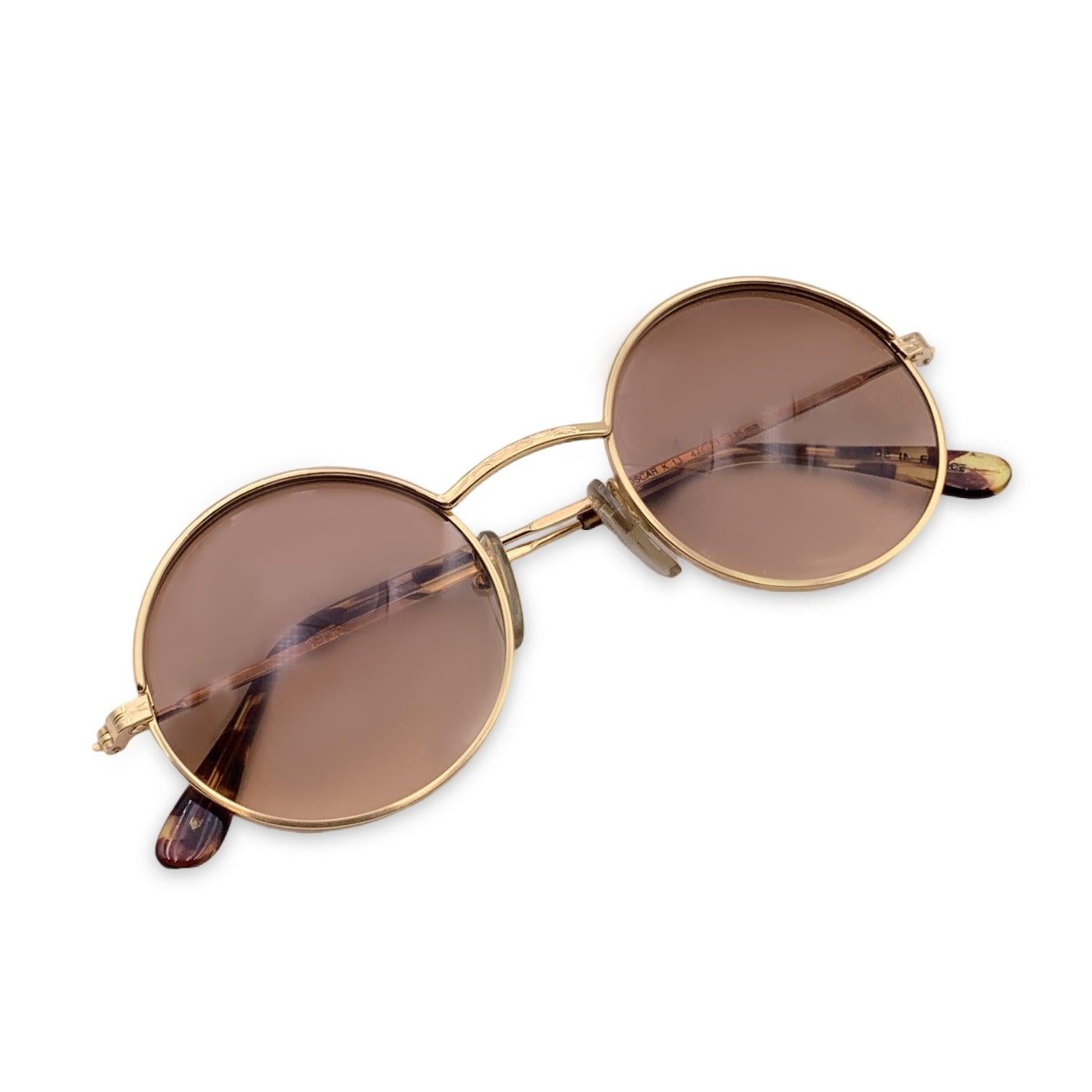 Vintage KENZO Oval sunglasses. Model. Oscar K 13 Size: 47/23 135 mm. Gold metal frame and temples with a brown tortoise acetate on the finish. 100% Total UVA/UVB protection .Gradient Brown lenses. Made in France. Condition A+ - MINT Never worn or