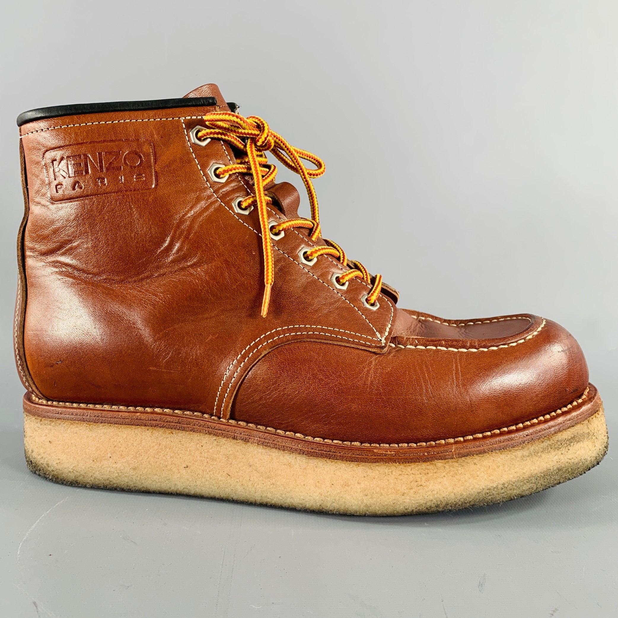 KENZO boots
in a sturdy brown leather featuring white contrast stitching, crepe sole, and side zipper closure. Made in Spainches Very Good Pre-Owned Condition. Moderate scuffs and signs of wear. Please check photos. 

Marked:   IT 43 

Measurements:
