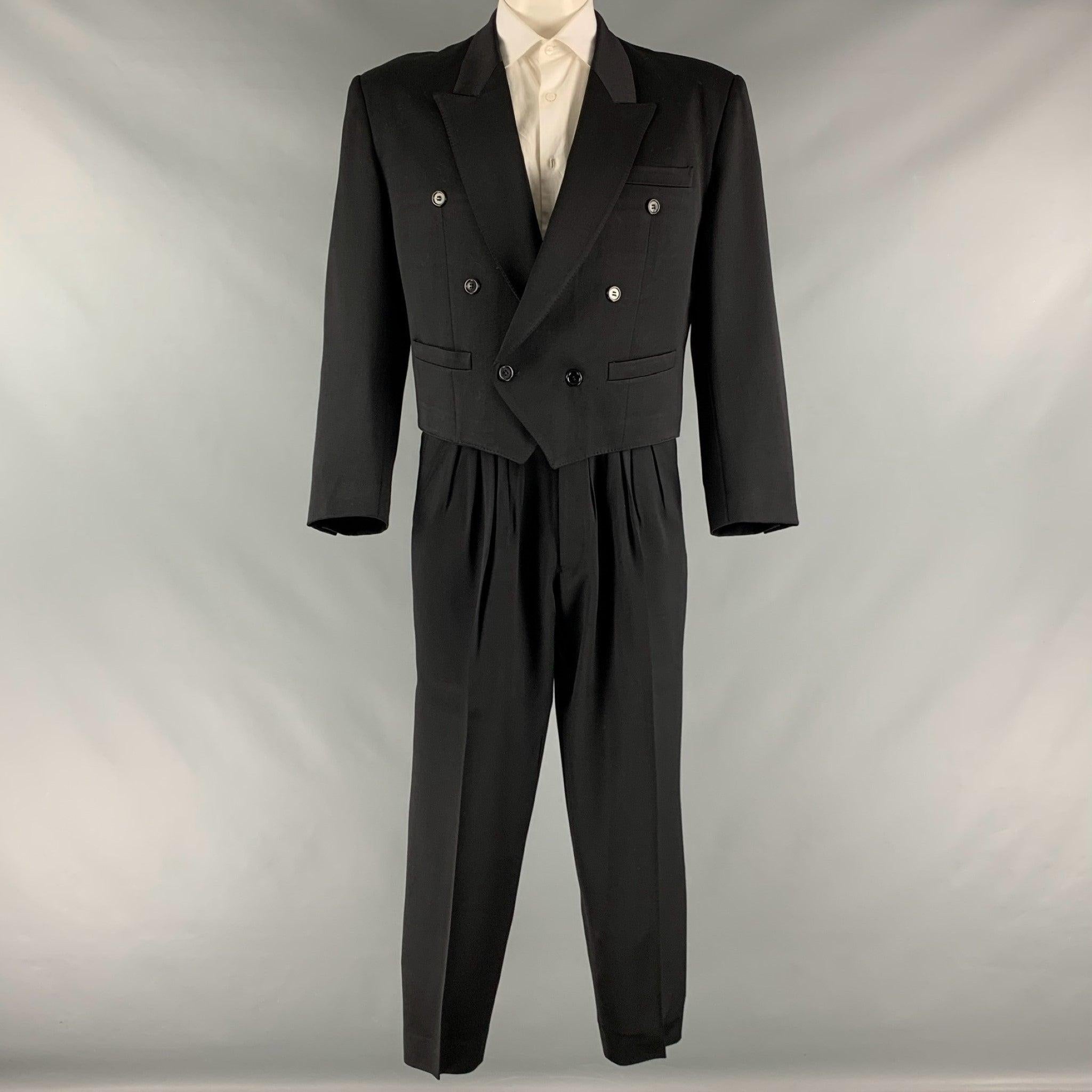 KENZO suit comes in a black wool with a full liner and includes a double breasted, cropped style sport coat with a peak lapel and matching pleated front trousers.Very Good Pre-Owned Condition.
Moderate signs of wear. 

Marked:   3 

Measurements: 
 