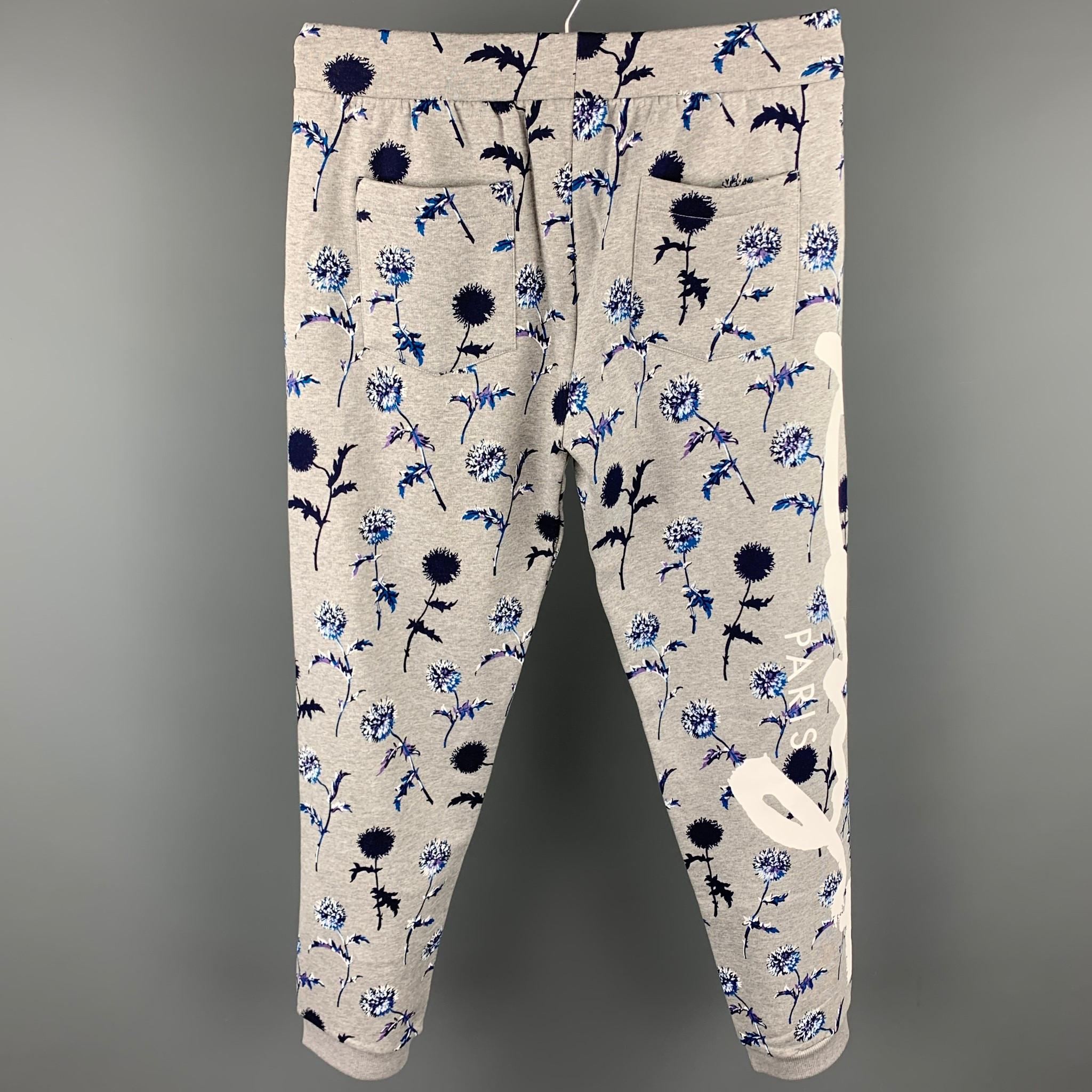 KENZO sweatpants comes in a grey floral cotton with a side logo design featuring slit pockets, elastic waistband, drawstring, and a zip fly closure. Made in Portugal.

Very Good Pre-Owned Condition.
Marked: L

Measurements:

Waist: 32 in.
Rise: 12