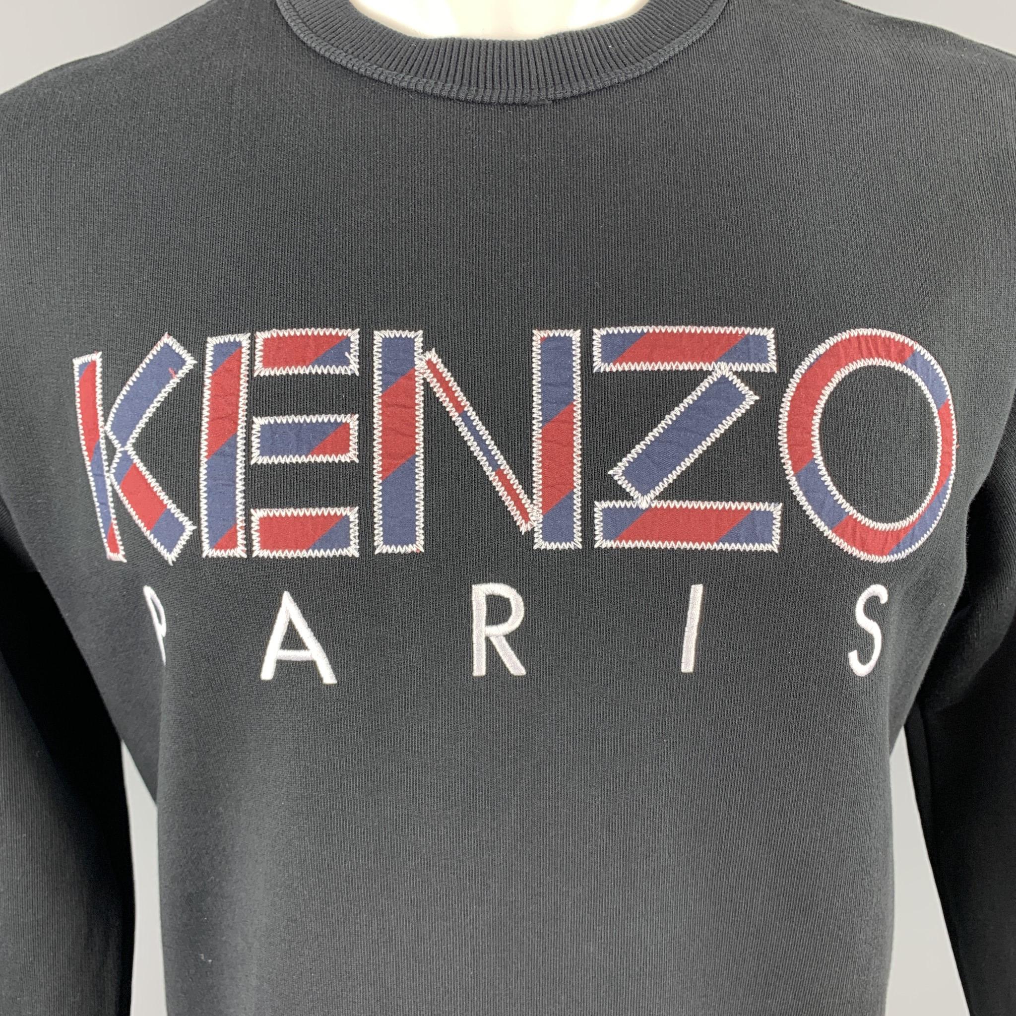 KENZO pullover comes in black jersey with a navy and burgundy embroidered logo graphic. Made in Portugal. 

Excellent Pre-Owned Condition.
Marked: M

Measurements:

Shoulder: 18 in.
Chest: 42 in.
Sleeve: 25 in.
Length: 25 in.