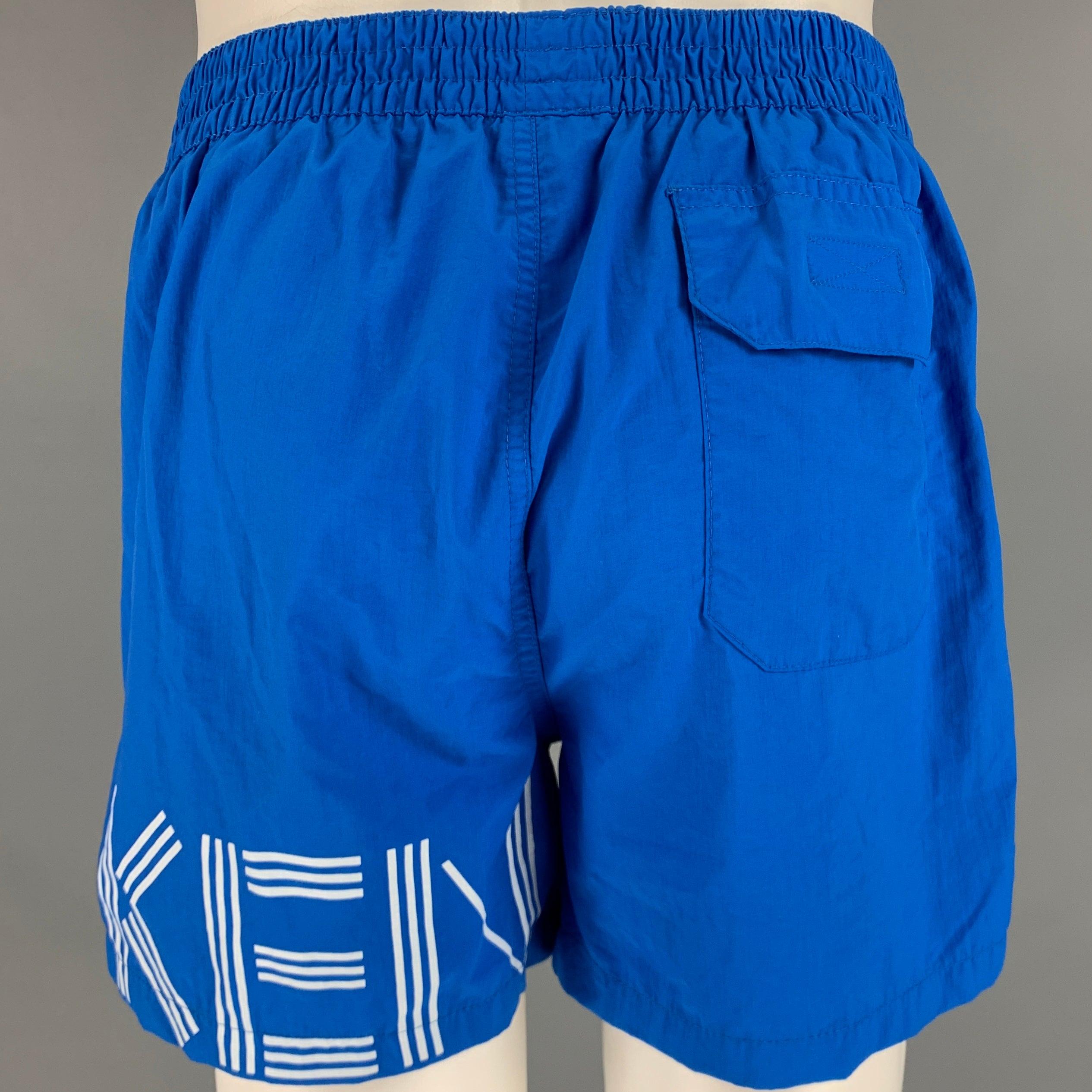 KENZO swim trunks in a
blue and white nylon fabric featuring signature logo wrapping around left thigh, two pockets, and elastic waistband.Excellent Pre-Owned Condition. 

Marked:   M 

Measurements: 
  Waist: 29 inches Rise: 9.5 inches Inseam: 4