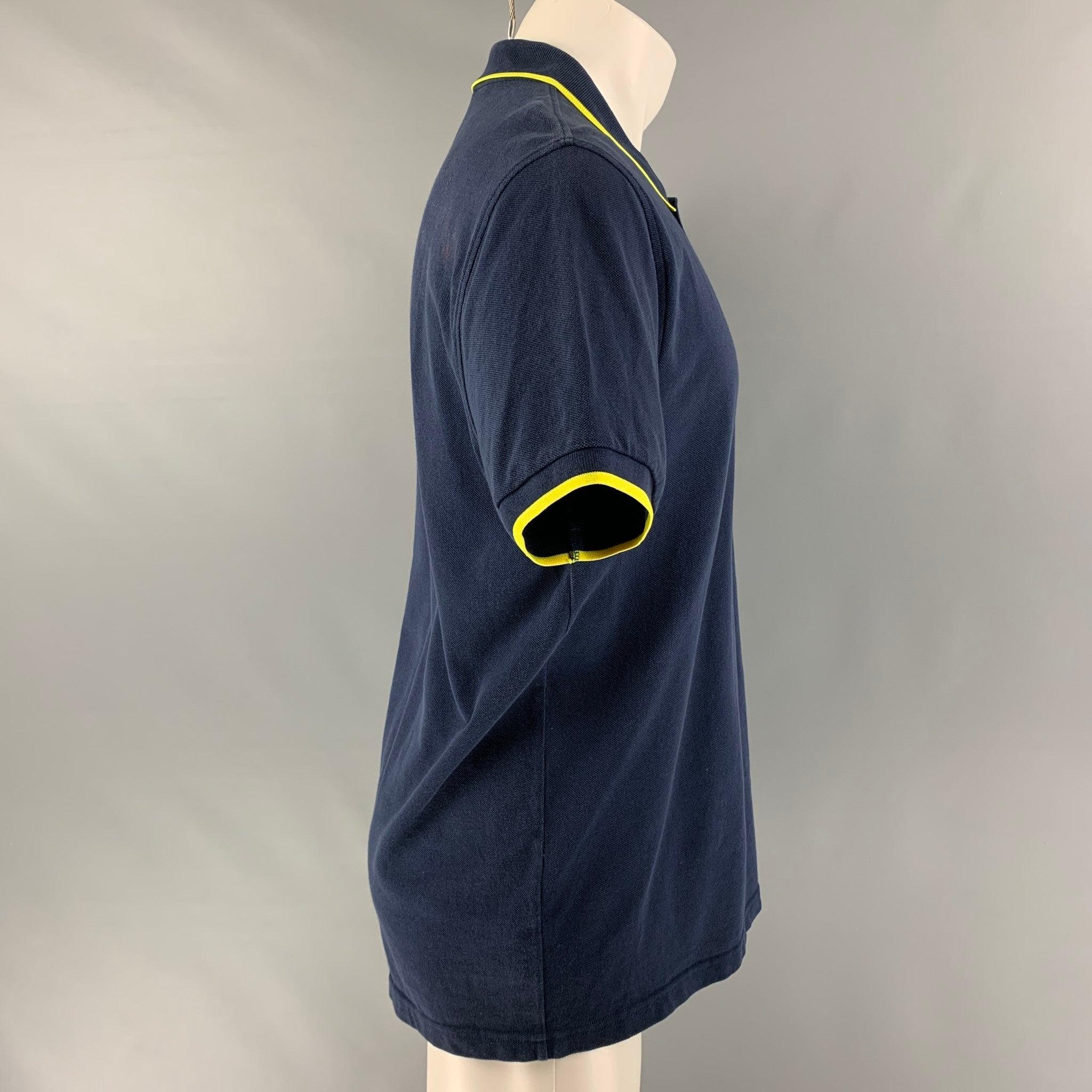 KENZO polo comes in a navy piquet fabric featuring a spread collar, embroidered logo, and a half buttoned closure. Good Pre-Owned Condition. Moderate signs of wear. Moderate discoloration at back. As-is. 

Marked:   no size marked 

Measurements: 

