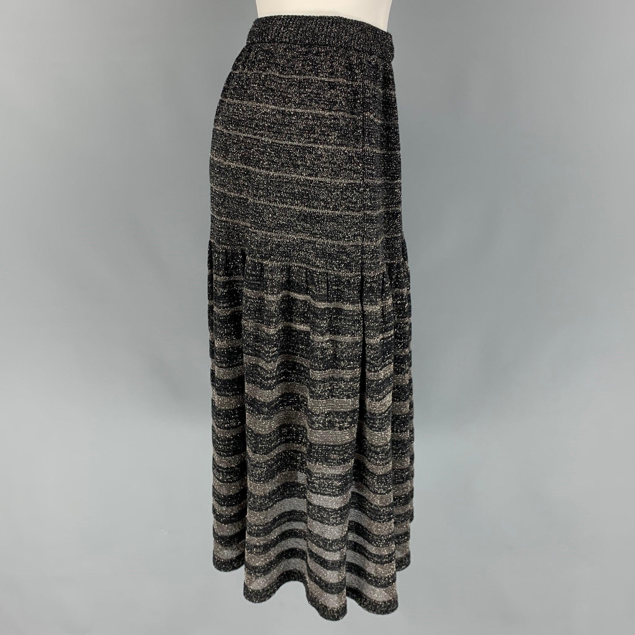 KENZO skirt comes in a black & silver knitted acrylic blend featuring a mid-calf length, a-line, and a elastic waistband.
Very Good
Pre-Owned Condition. 

Marked:   S 

Measurements: 
  Waist: 25 inches  Hip:
34 inches  Length: 28 inches 
  
  

