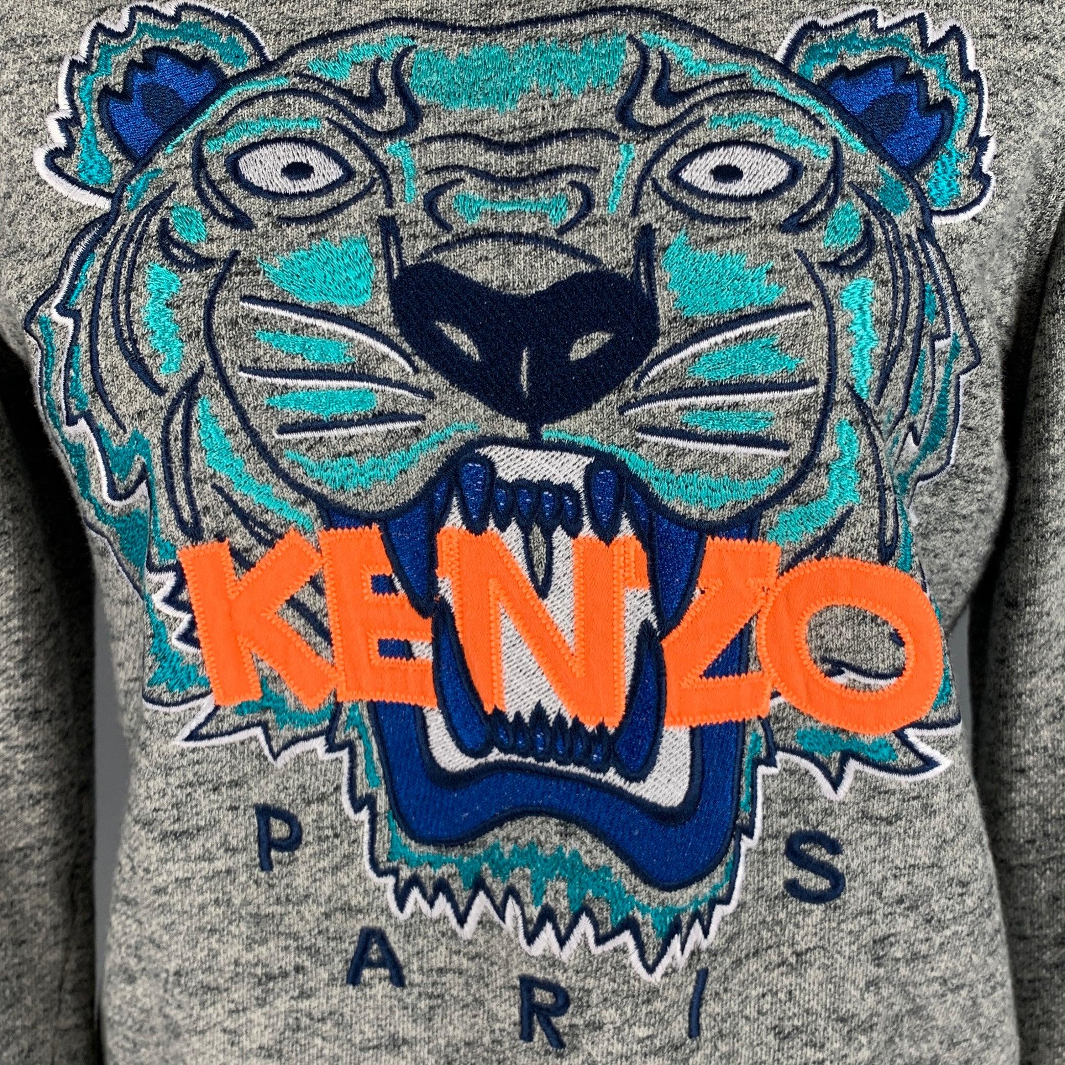 KENZO sweatshirt
in a grey cotton fabric featuring embroidered orange logo with blue tiger, and crew neck.Excellent Pre-Owned Condition. 

Marked:   S 

Measurements: 
 
Shoulder: 15.5 inches Bust: 36 inches Sleeve: 22.5 inches Length: 20 inches 
 