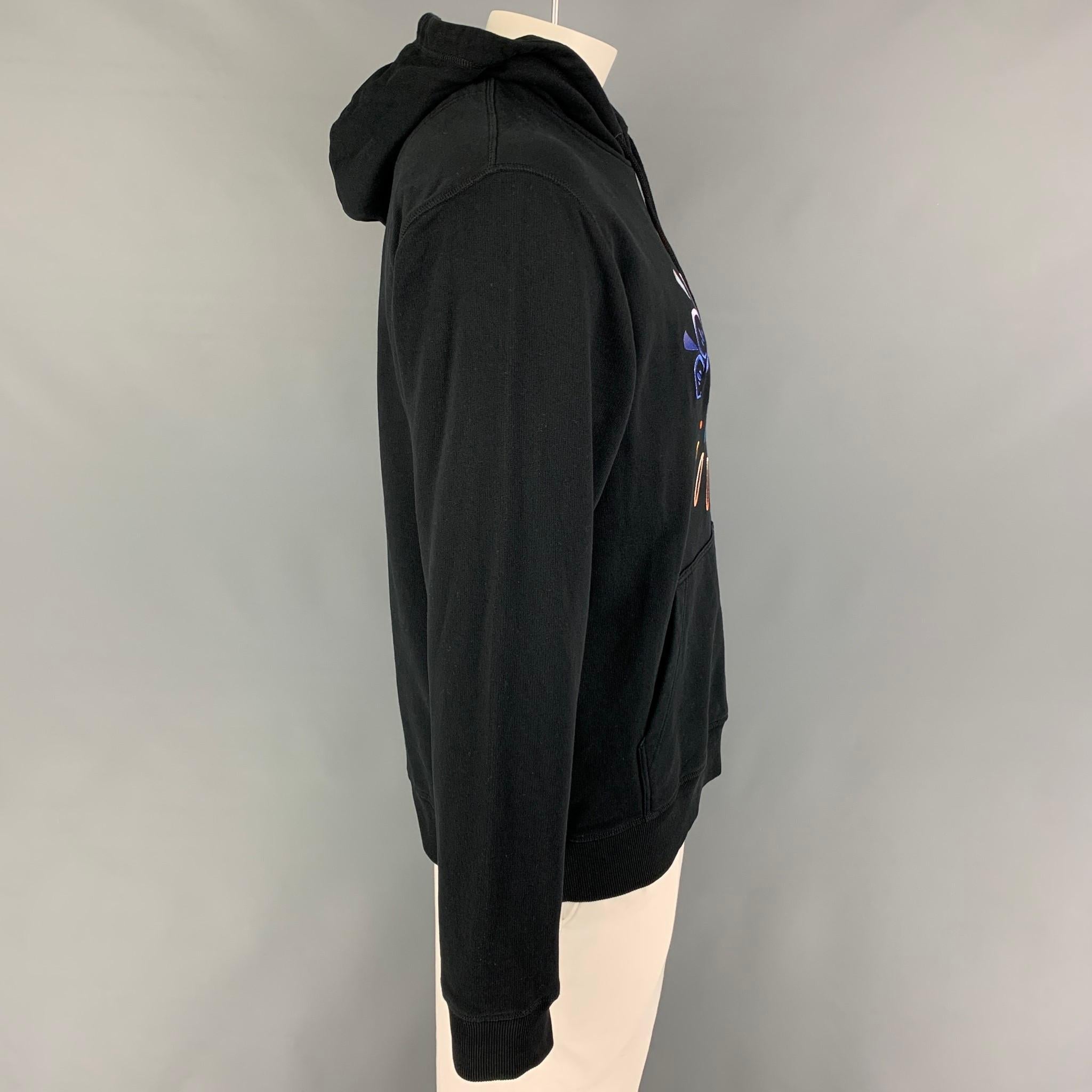 KENZO sweatshirt comes in a black cotton featuring a multi-color 'eye' embroidered design, hooded, pouch pocket, and a drawstring detail.

Very Good Pre-Owned Condition.
Marked: XL

Measurements:

Shoulder: 20 in.
Chest: 46 in.
Sleeve: 27.5