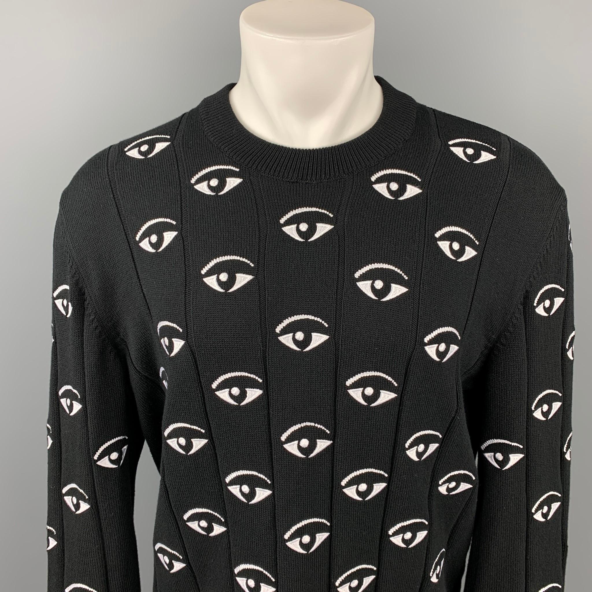 KENZO pullover comes in a black & white cotton with embroidered eyes throughout featuring a crew-neck. 

Very Good Pre-Owned Condition.
Marked: XL
Original Retail Price: $525.00

Measurements:

Shoulder: 21 in.
Chest: 46 in.
Sleeve: 29 in.
Length: