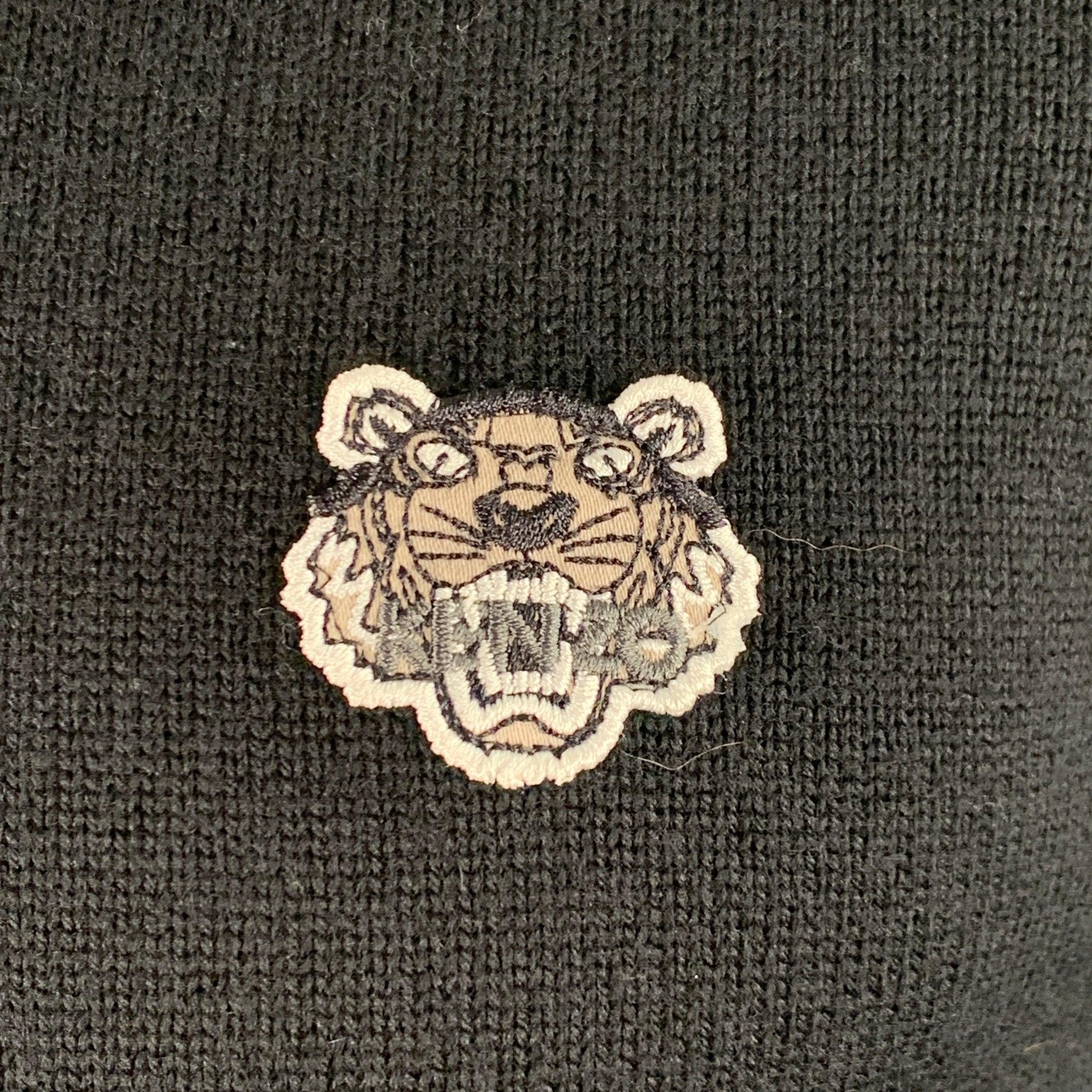 KENZO PARIS sweater in a black wool blend knit featuring a collarless style, contrasting navy trim, KENZO tiger patch, and zip up closure.Excellent Pre-Owned Condition. 

Marked:   XS 

Measurements: 
 
Shoulder: 15.5 inches Chest: 36 inches Sleeve: