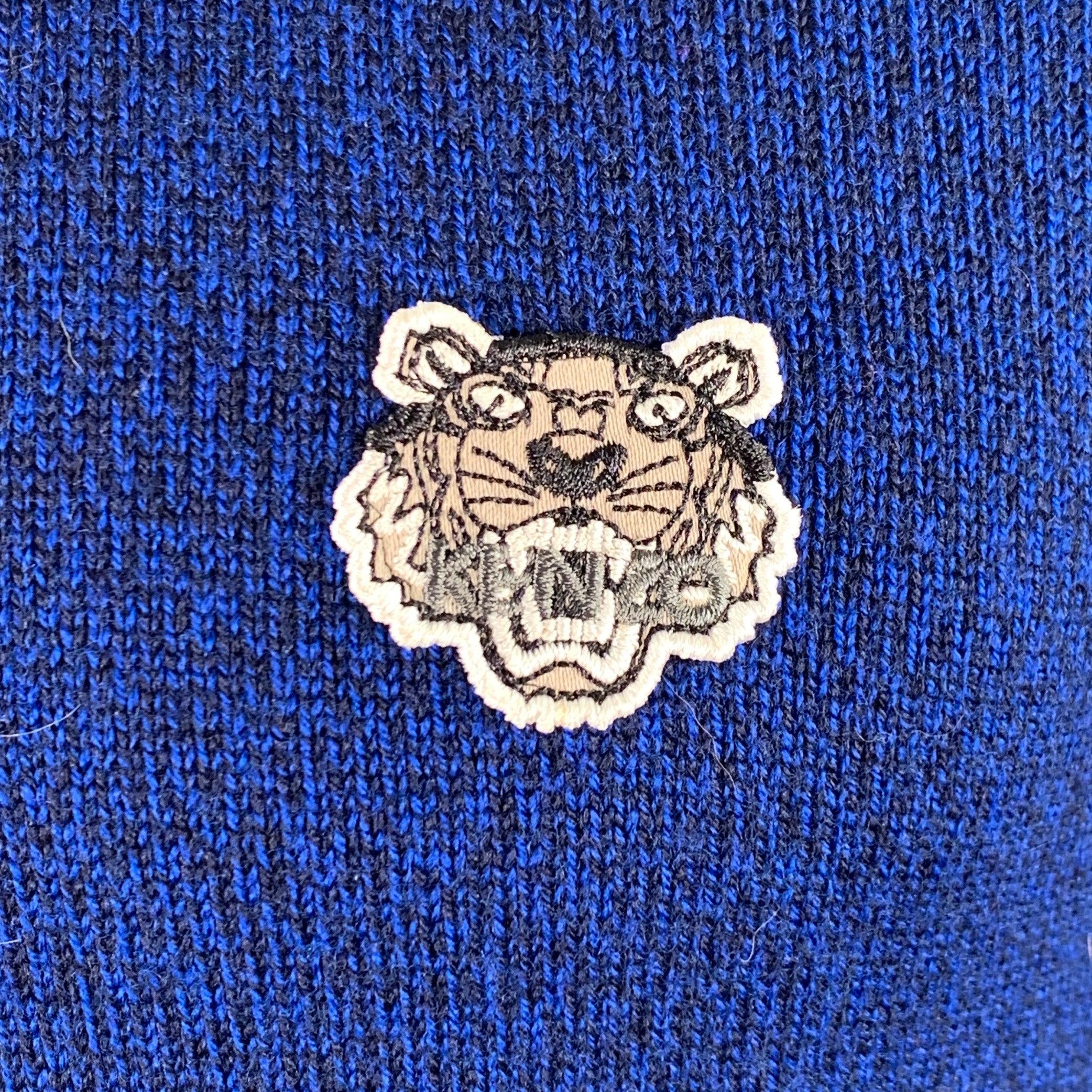 KENZO PARIS pullover in a blue and black cotton knit featuring contrasting black trim, KENZO tiger patch, and crew neck. Excellent Pre-Owned Condition. 

Marked:   XS 

Measurements: 
 
Shoulder: 17 inches Chest: 36 inches Sleeve: 26.5 inches 
