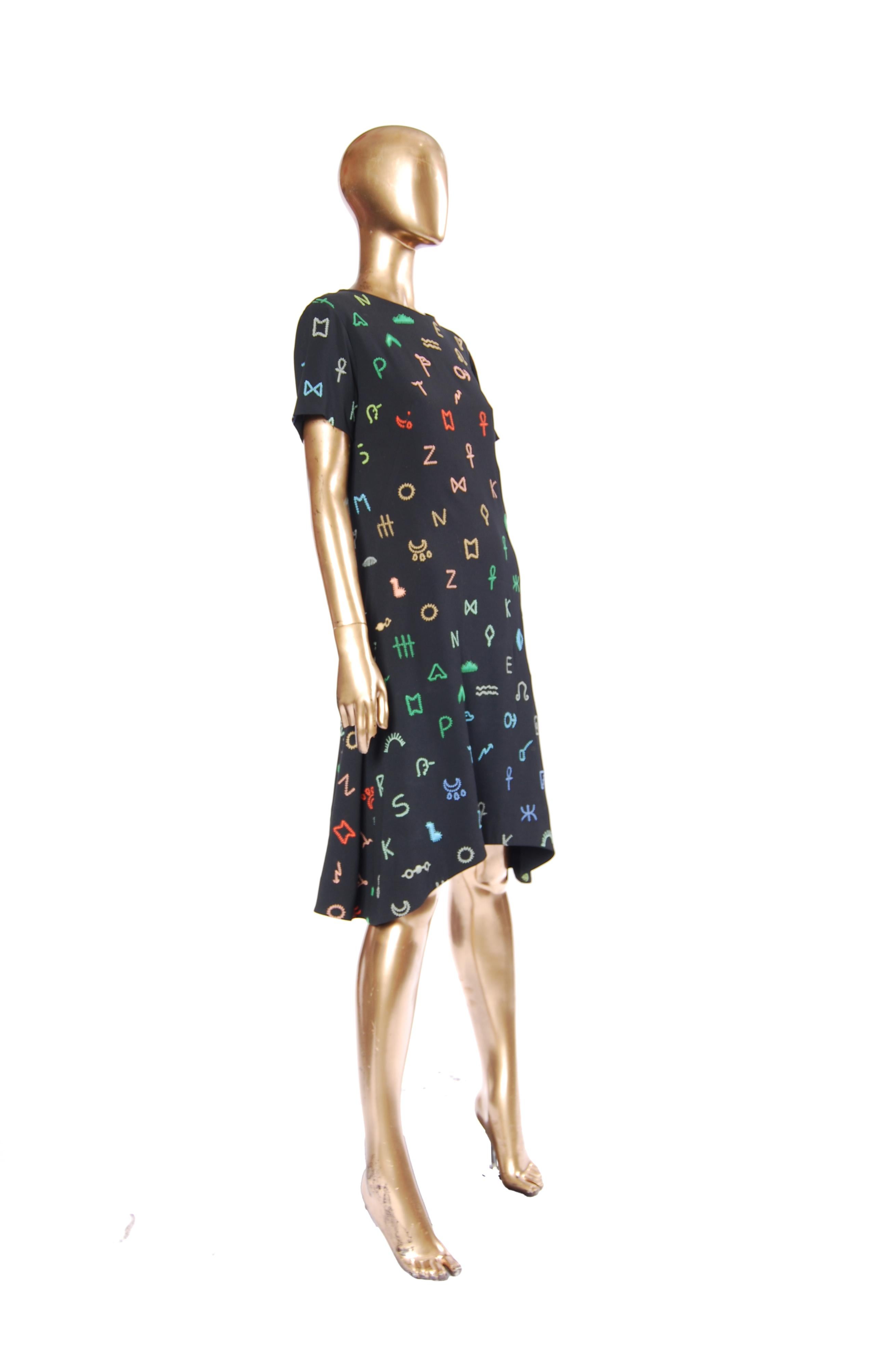 Make a bold statement with this eye catching kenzo dress crafted in crepe with embroidered symbols,  it offers a fresh take on celestial style. Perfect for those who love fashion with personality. Tailored for a flattering, structured fit, this
