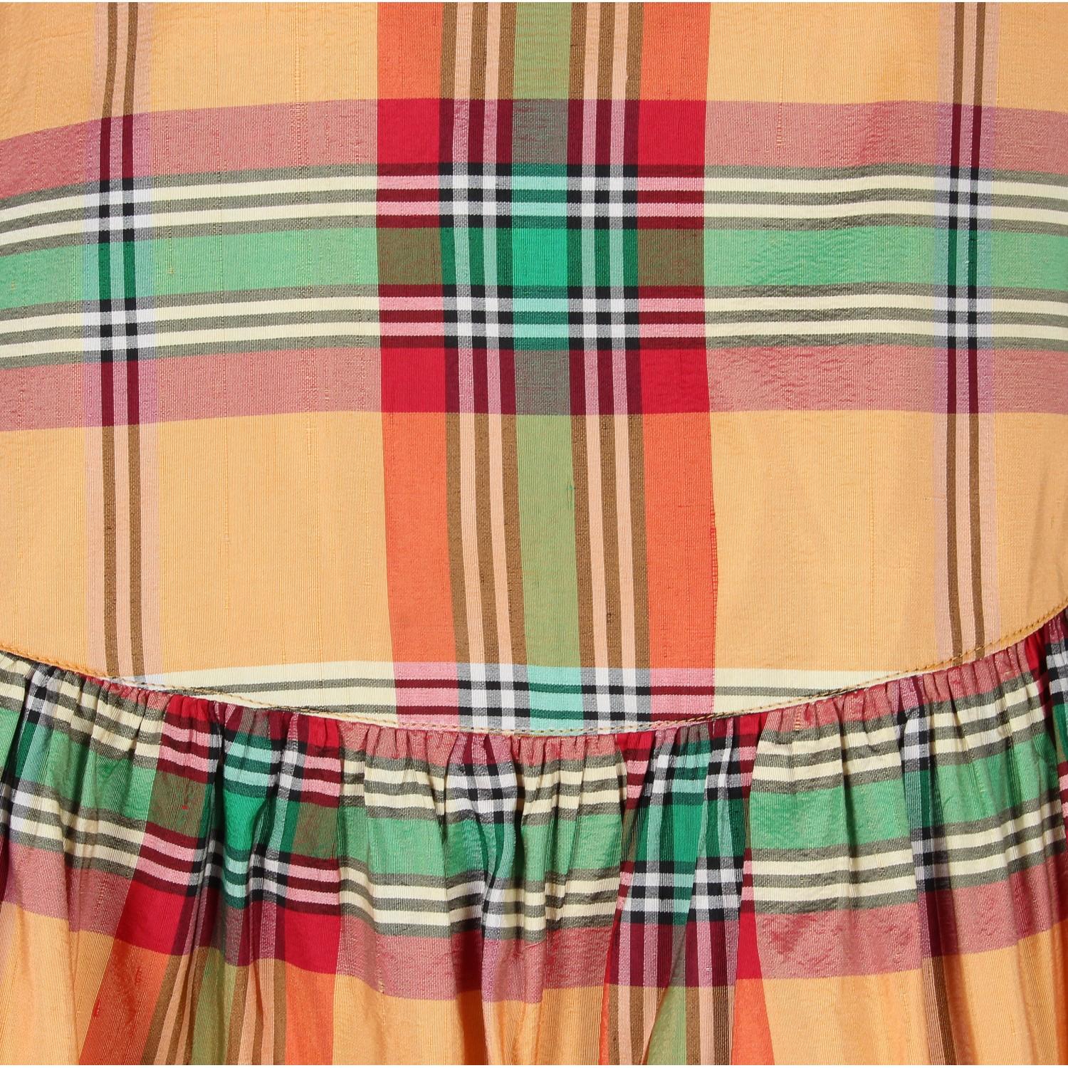 Kenzo orange, green, white and red tartan shantung silk skirt. It has two frills and one decorative bow on the back. The item is vintage, it was produced in the 1990s and is in very good conditions but it shows one little mend on waist lining, as in
