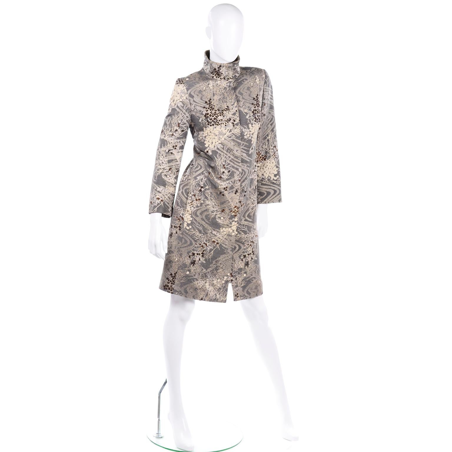 This beautiful vintage Kenzo brocade coat has metallic threads throughout and earth tones consisting of grey, brown, gold, tan, and cream. The shoulders are perfectly structured with shoulder pads and the fit of the coat is very slim and tailored.