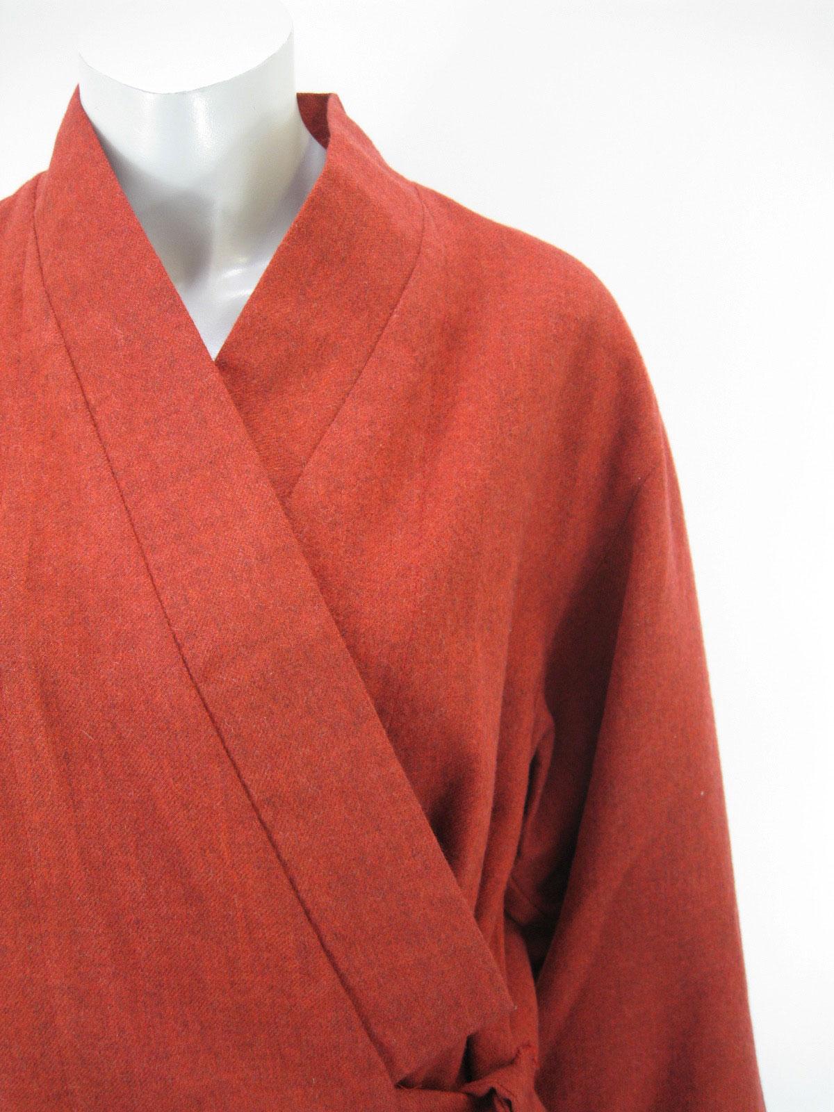 Vintage Kenzo Paris short wool kimono style jacket.

Wrap front with inside and outside ties.

Wide loose sleeves.

Fabric is wool. Red with woven black undertones.

Partial lining is cotton.

No size tag.

Made in France.

This item is in very good