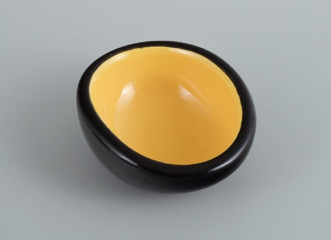 Mid-Century Modern Keramos, Sèvres, France. 3 unique ceramic bowls glazed in yellow and black.