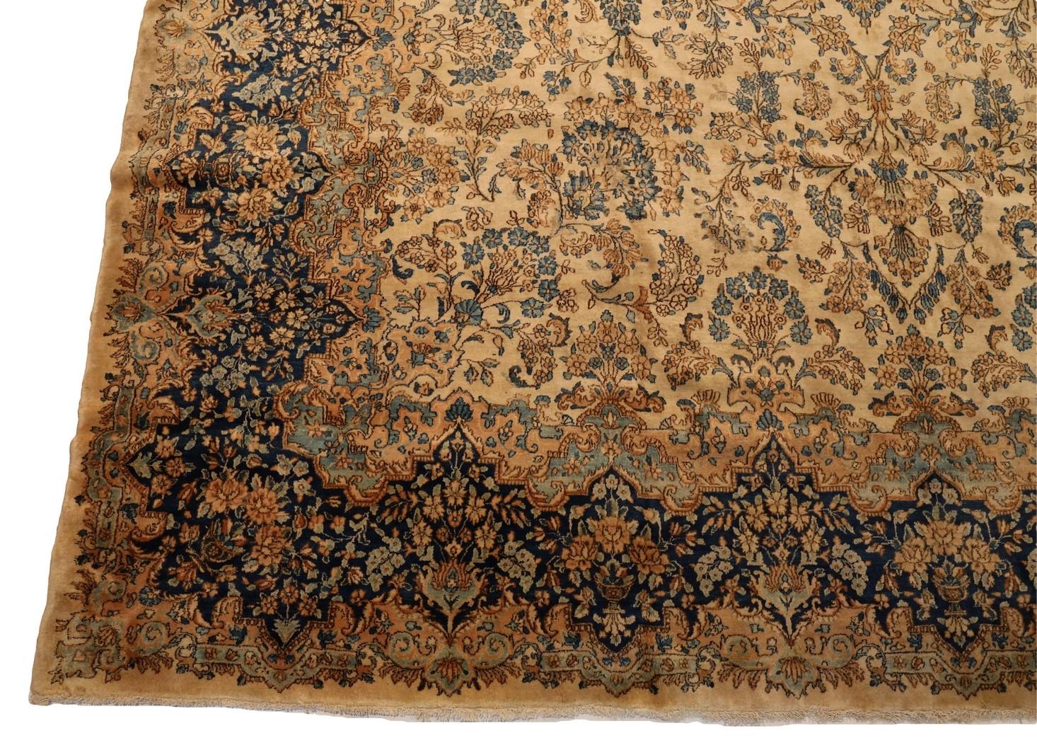 Tauchen Sie ein in die fesselnde Anziehungskraft eines Kerman Teppichs, dessen Schönheit sich auf einer erhabenen beigen Leinwand entfaltet, die mit einer Reihe bezaubernder Blumenmotive geschmückt ist. Dieses exquisite Meisterwerk haucht jedem Raum