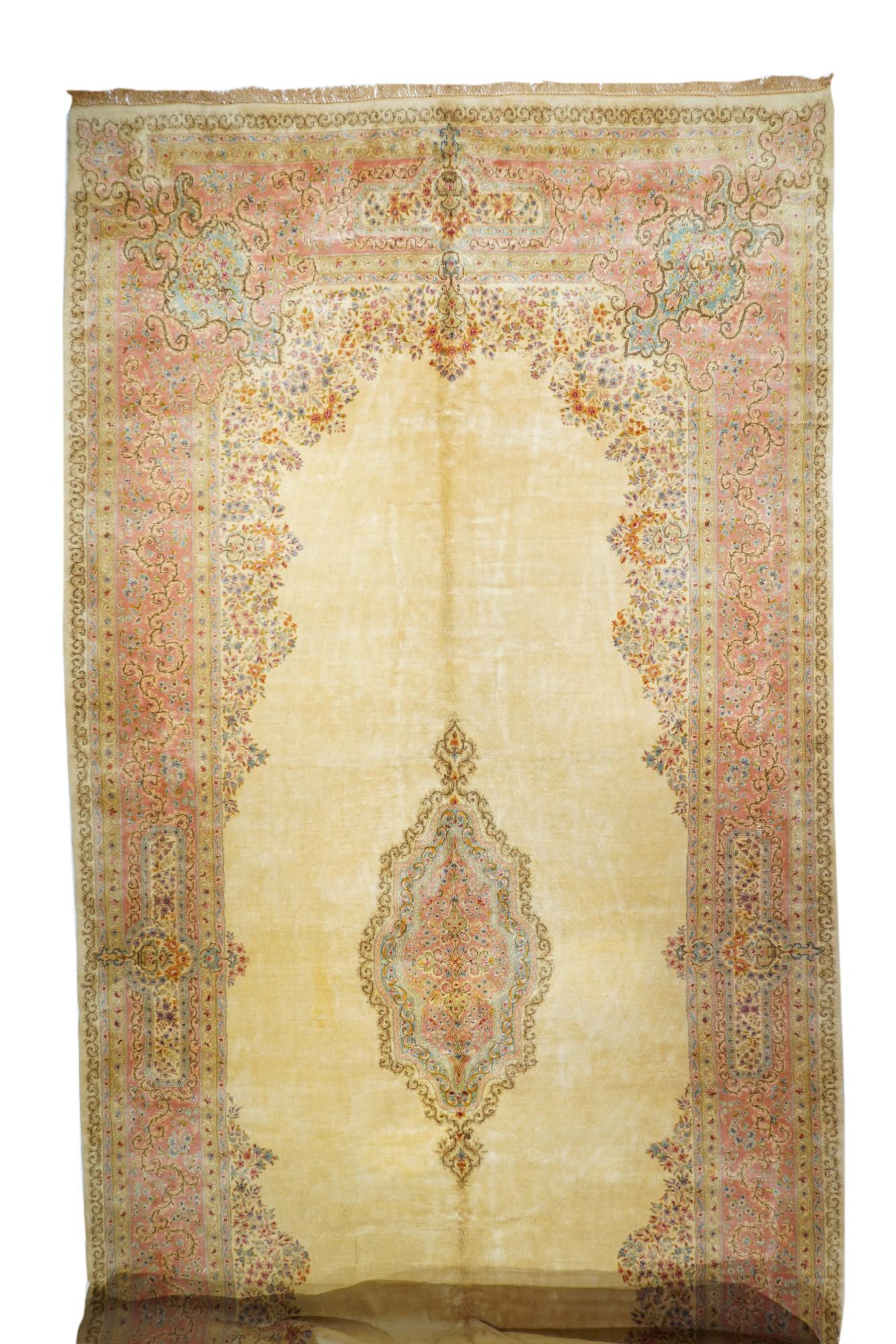 This post-WWII SE Persian bespoke city carpet, clearly woven for the American Market, shows a natural straw-ecru open field hosting a layered light blue/light green cartouche medallion, framed by extended openwork foliage filigree corners. Rust