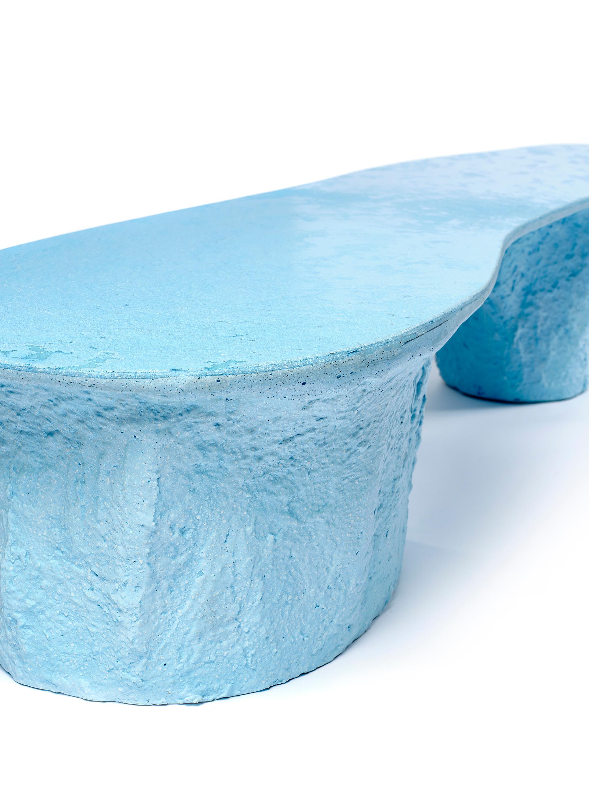 The light blue Kernel table is a unique piece made entirely by hand by the designer. Completely built in Glebanite, a special blend of recycled and recyclable fiberglass. An artistic work of circular economy that takes care of the planet earth and
