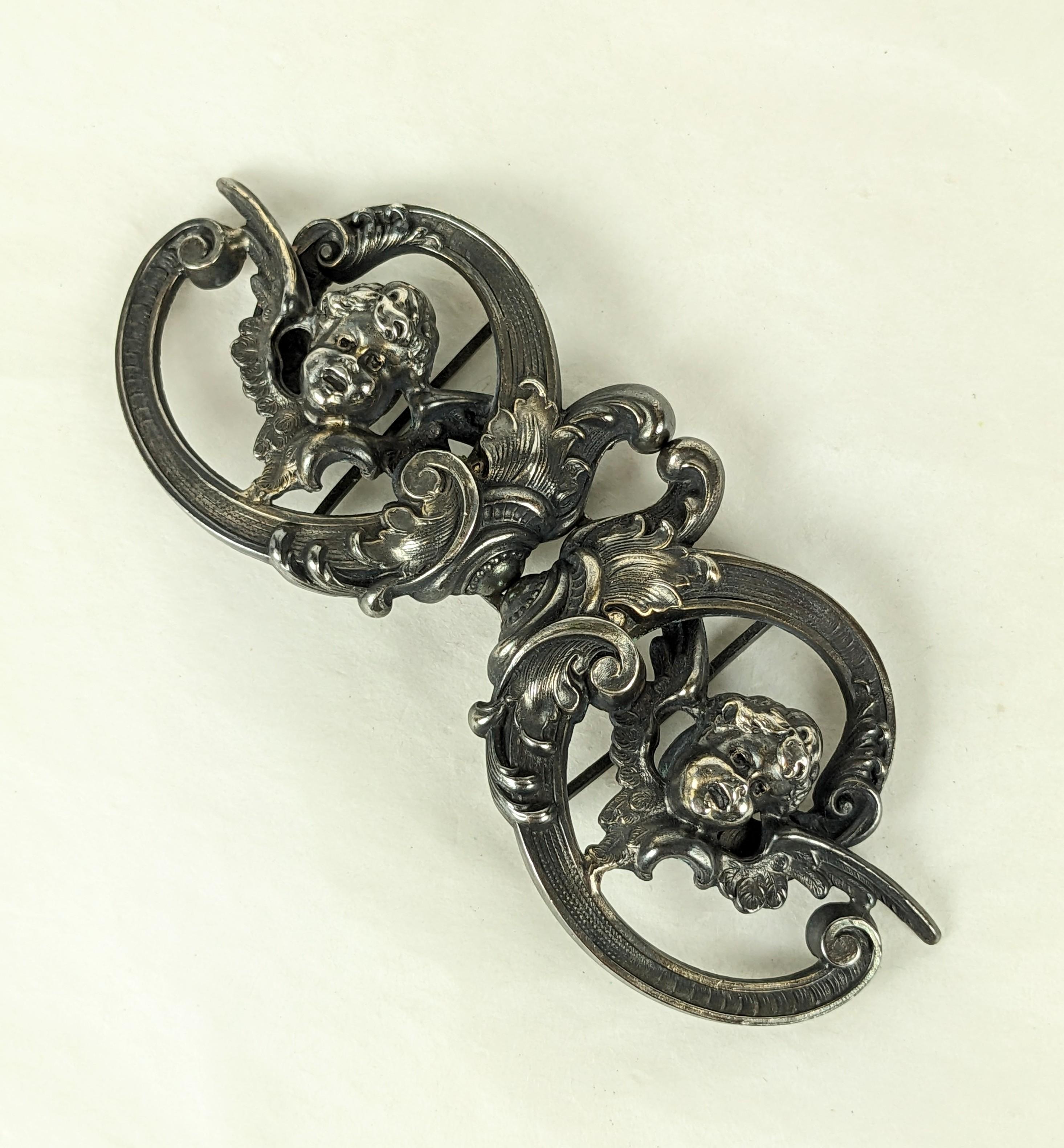 Charming Kerr Sterling Victorian Angel Buckle from the late 19th Century. High repousee angels motifs in scrollwork frames.. Signed with Kerr hallmark, Sterling. USA 1880's. 4