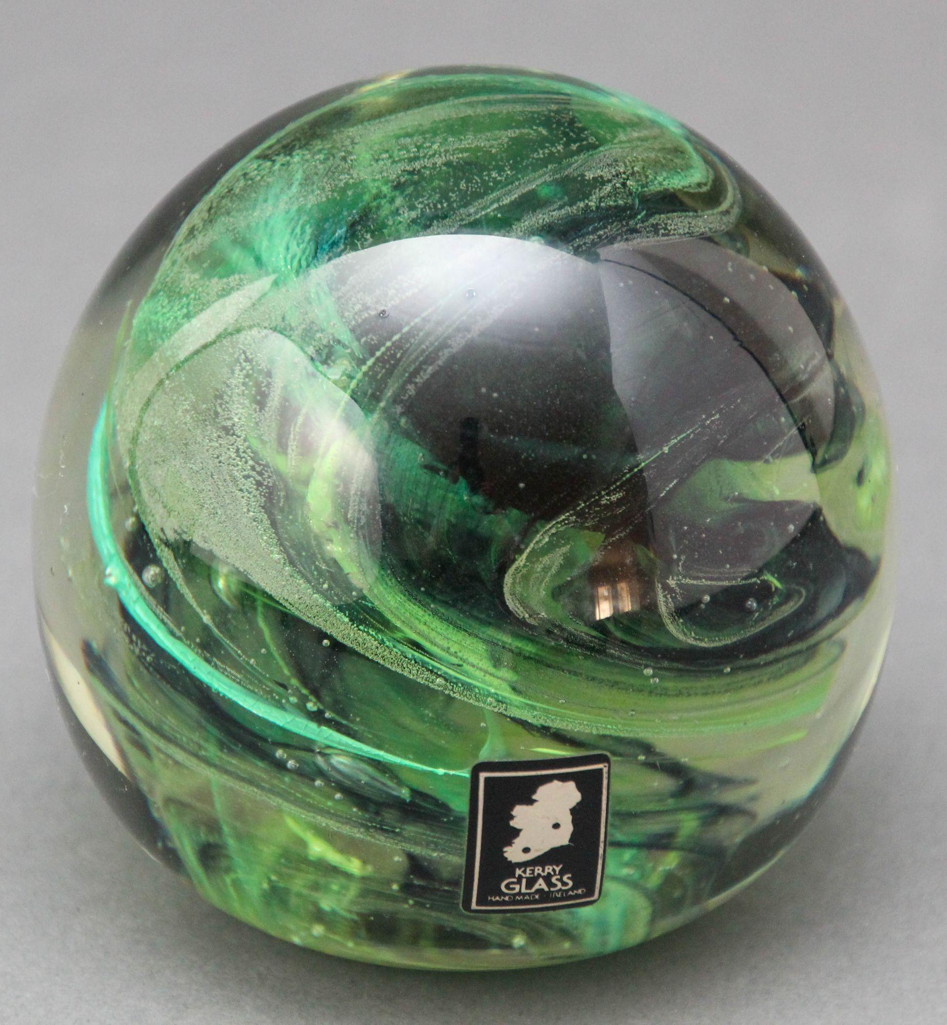Vintage Kerry art glass paperweight hand blown in dark olive green, jade and emerald colors with small bubbles.
Hand crafted in Ireland, circa 1980s.
Sticker still attached.
Kerry Glass Hand made in Ireland.
Measures: diameter 3 inches, height 3