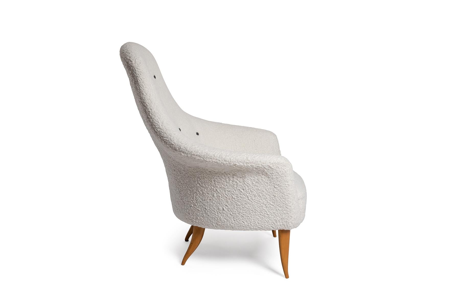 Kerstin Holmquist Eva chair circa early 1960's. This sculptural example has been newly upholstered in a faux lambskin and the legs have been newly finished.