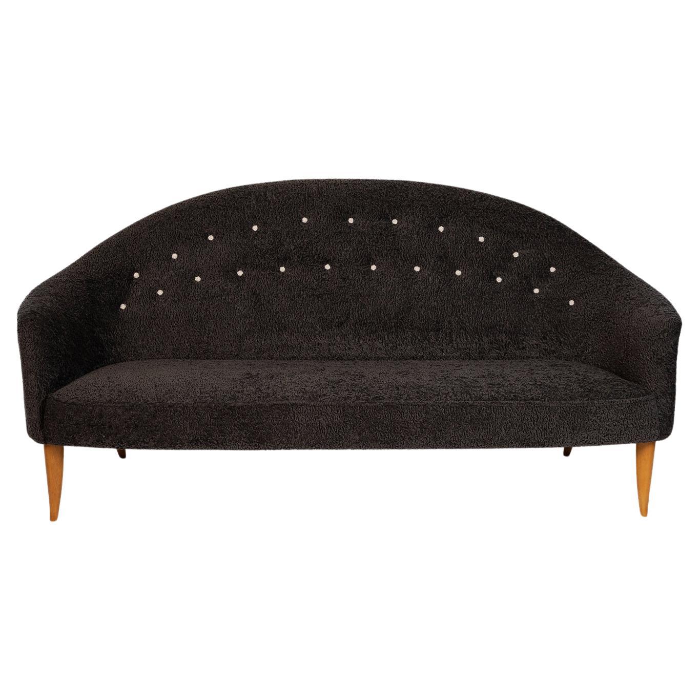 Kerstin Holmquist Paradiset sofa circa early 1960's. This example has been newly upholstered in a beautiful dark charcoal colored faux sheepskin. Legs have been newly finished as well.