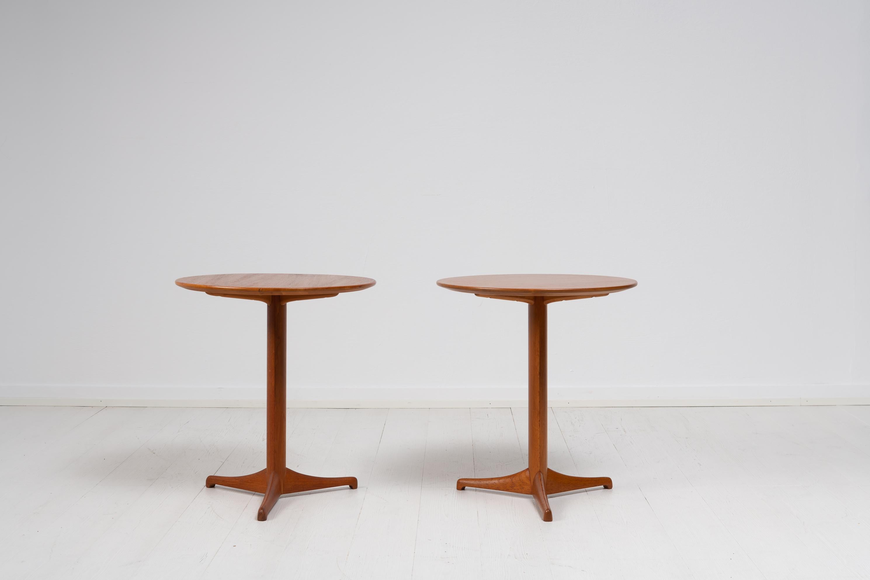 Pair of Scandinavian modern teak tables from Sweden. The tables are known as 
