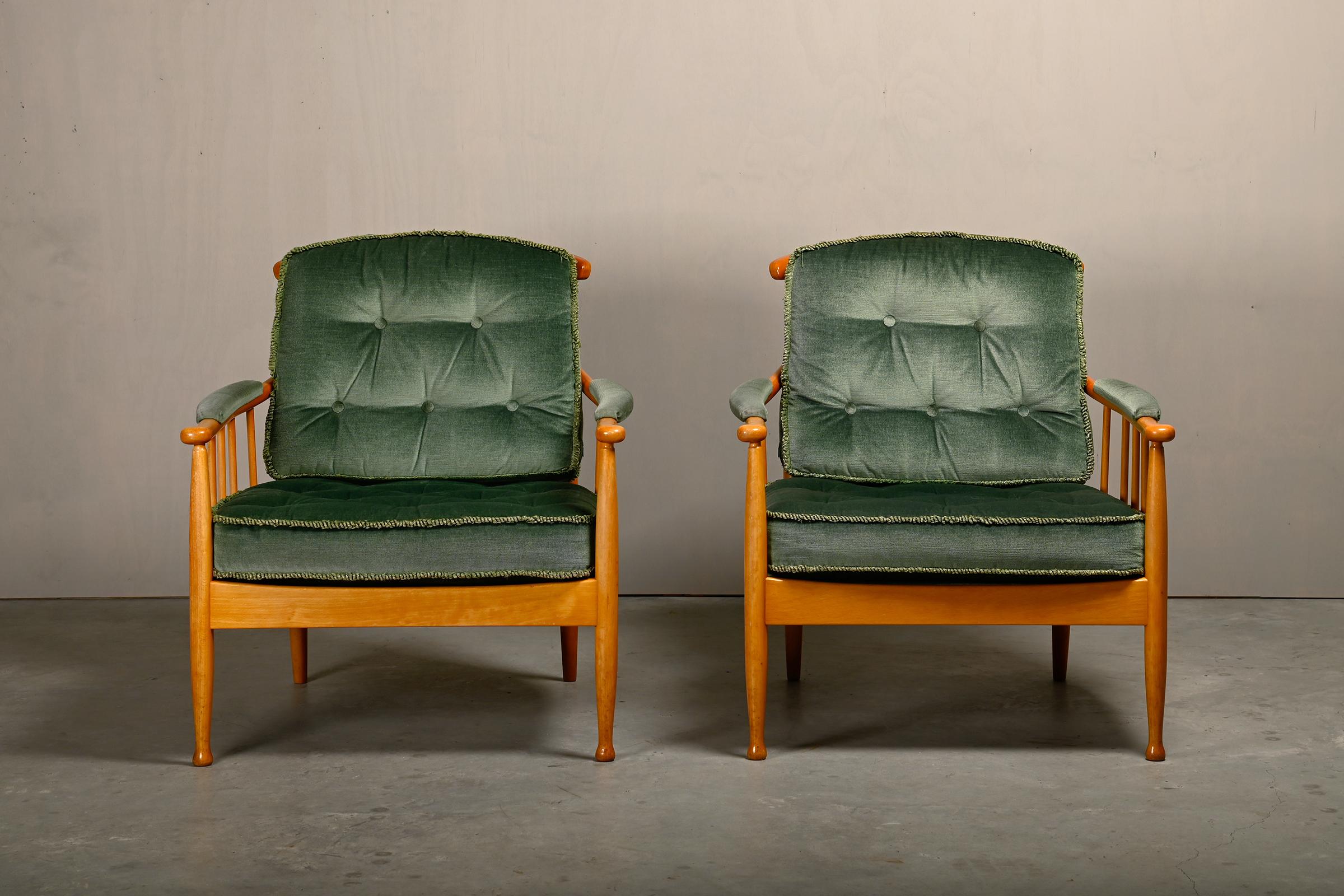 Beautiful pair of armchairs (model Skrindan), designed by Kerstin Hörlin-Homquist in 1963 for OPE Möbler, Sweden. Frame of solid beech with beautiful elegant details. Loose cushions covered with an original green velvet fabric and fringe piping. The