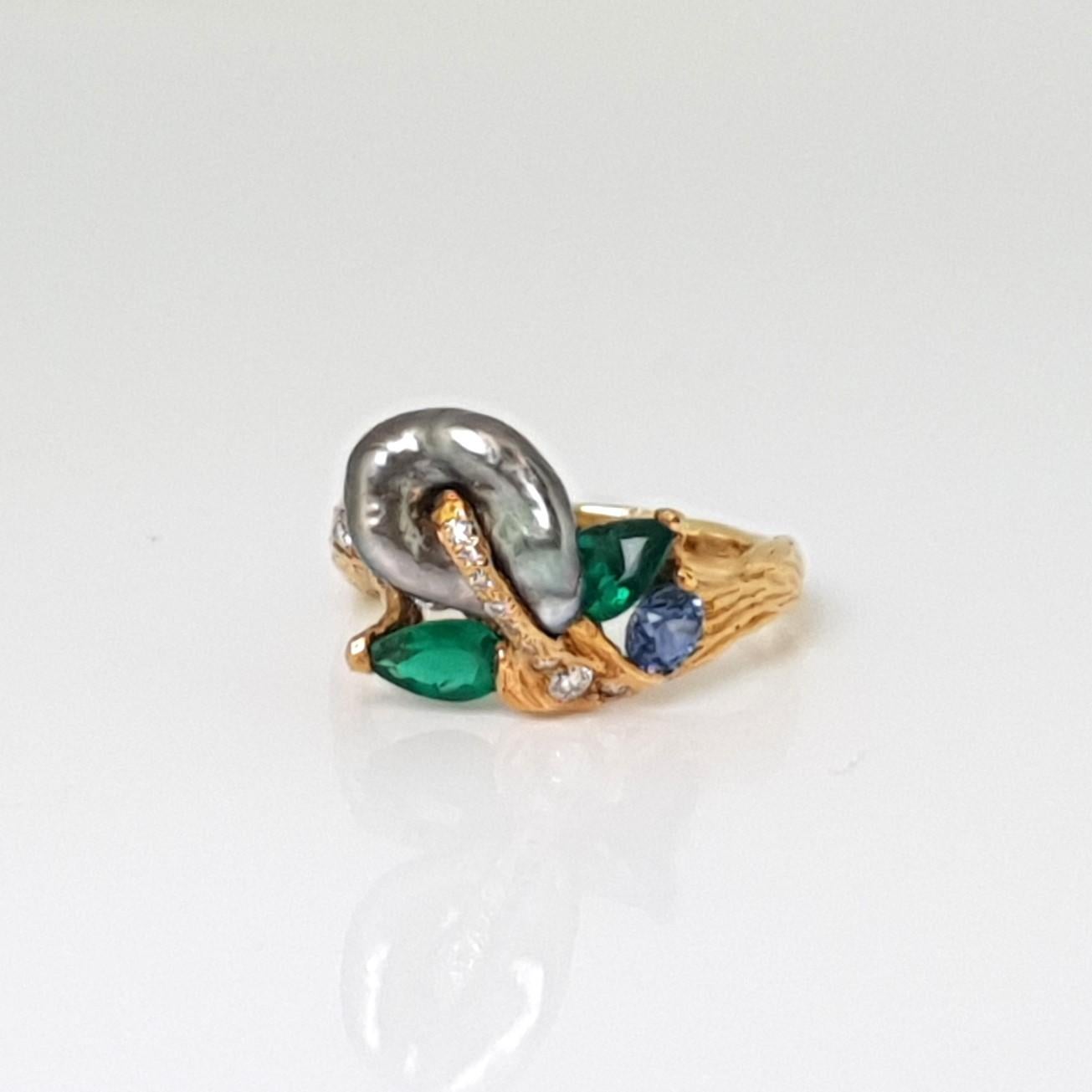 Indulge in the world of wearable art with the stunning Tahitian Keshi Diamond and Emerald Ring by MOISEIKIN🄬. This magnificent creation draws inspiration from the captivating brushstrokes of Vincent Van Gogh's impressionism, surpassing the limits