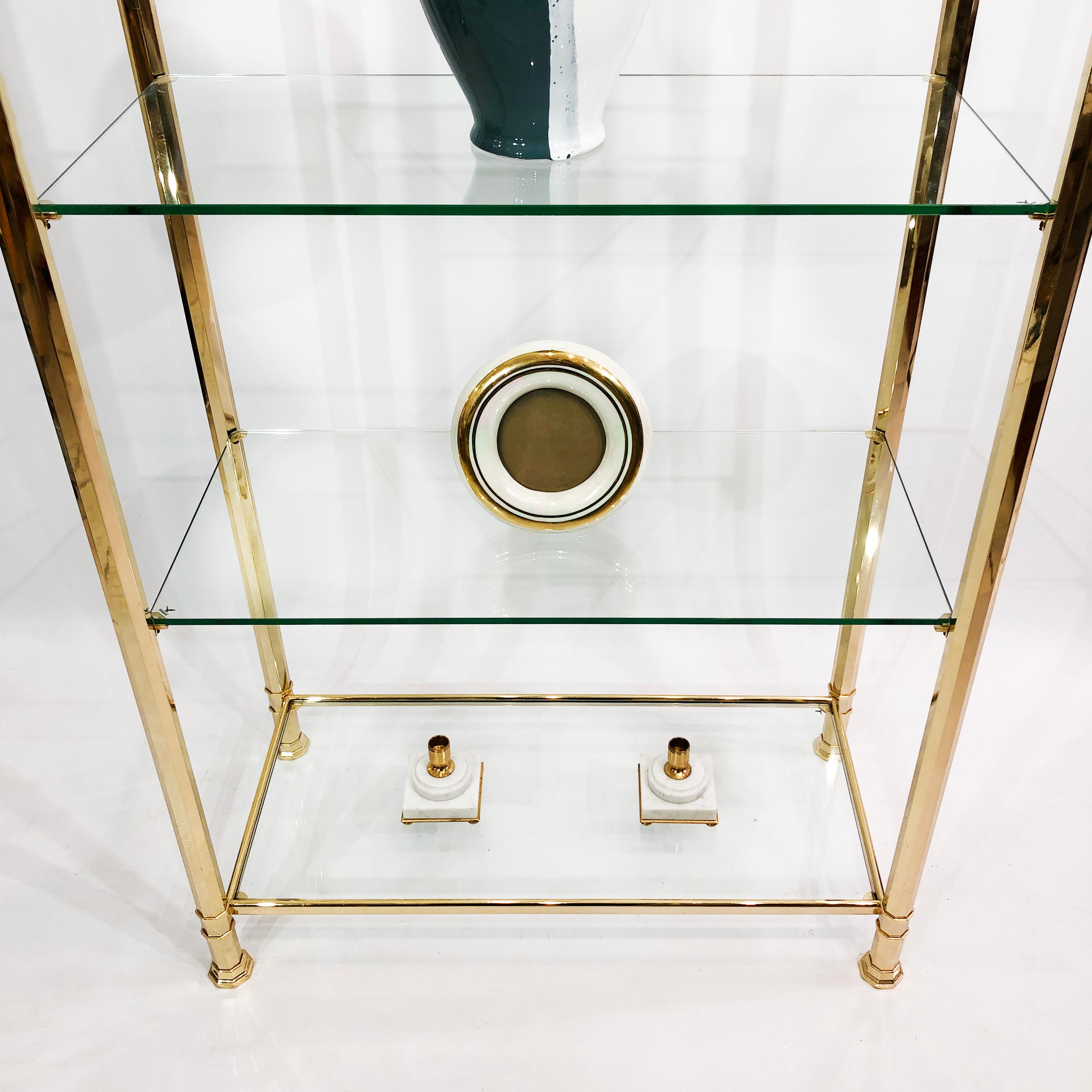 gold and glass shelving unit