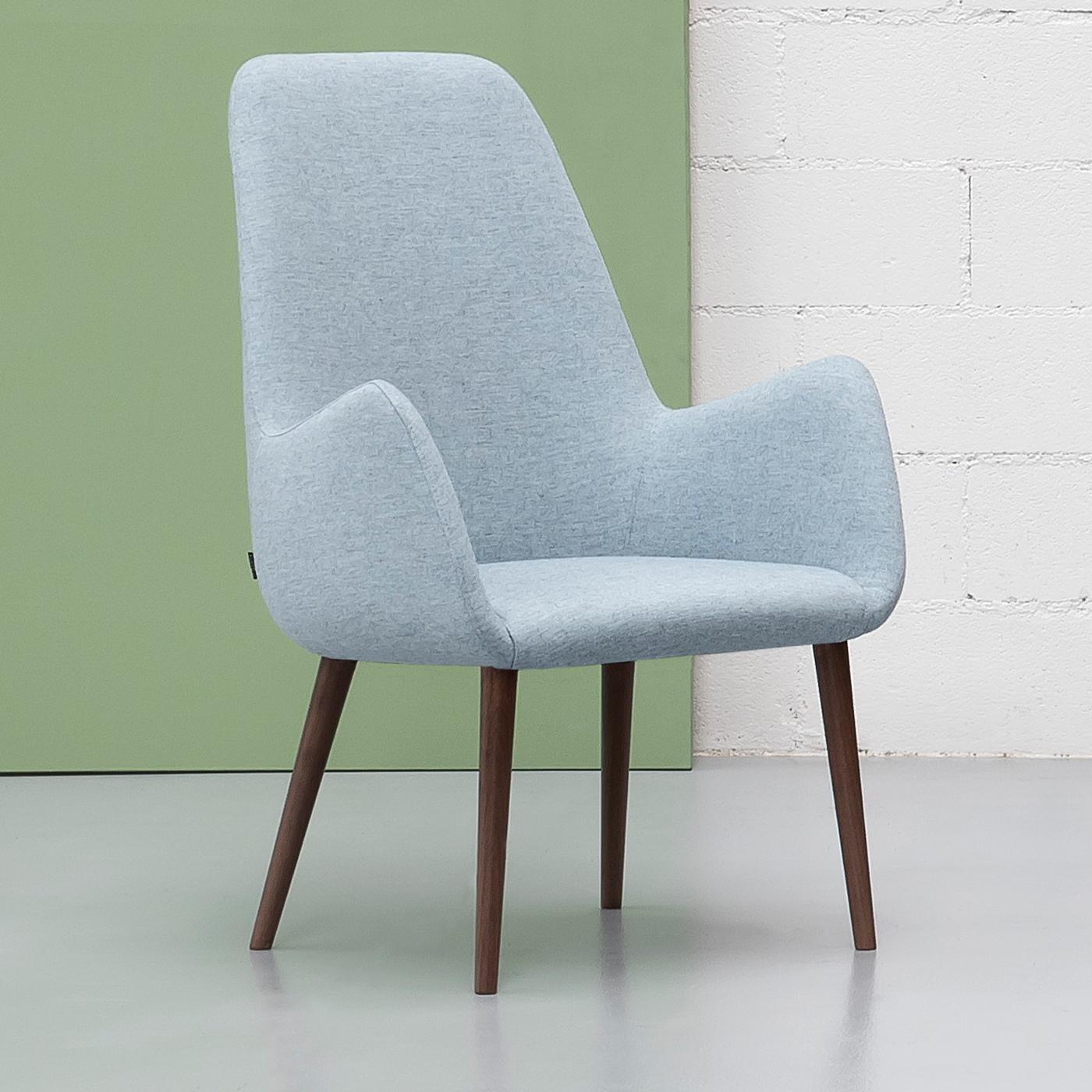 Designed by Carlesi & Tonelli, this plush armchair from the Kesy Collection creates a snug, cozy space while adding a stylish accent to any contemporary interior decor. Supported by four walnut-stained ash wood legs, the sophisticated and modern