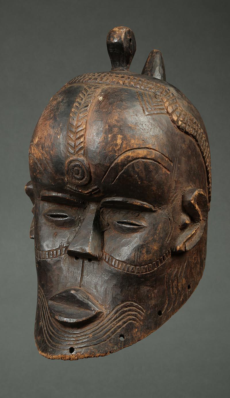 Kete tribal helmet mask, Congo, Africa

A Kete helmet mask with weaving scarification marks, Heavy wear and patina from native use. Old repairs to proper right eye and ear, On custom stand, mask 14 1/2