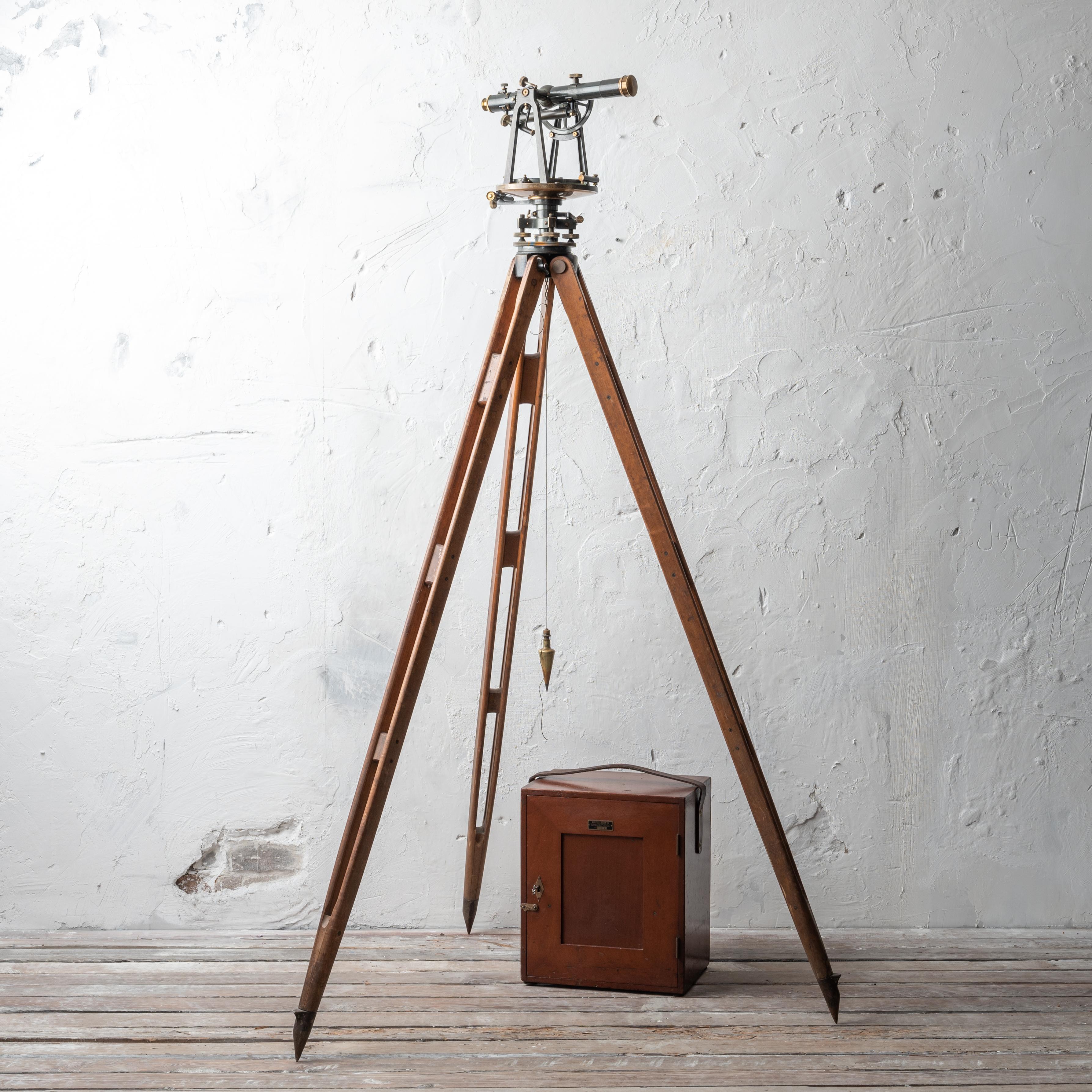 A 1912 Keuffel & Esser Co. railroad surveyor's transit. 

Includes outfitted mahogany case. All original with matching serials.

Approximately 70 inches tall with a 24 inch leg spread.

