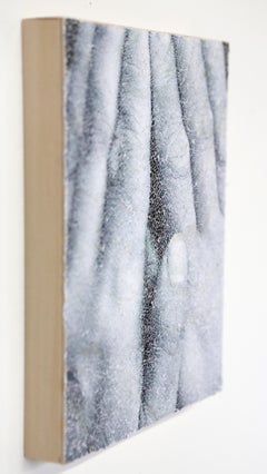 Hide #3- intricate collage of torn and pasted photograph of hands on wood panel