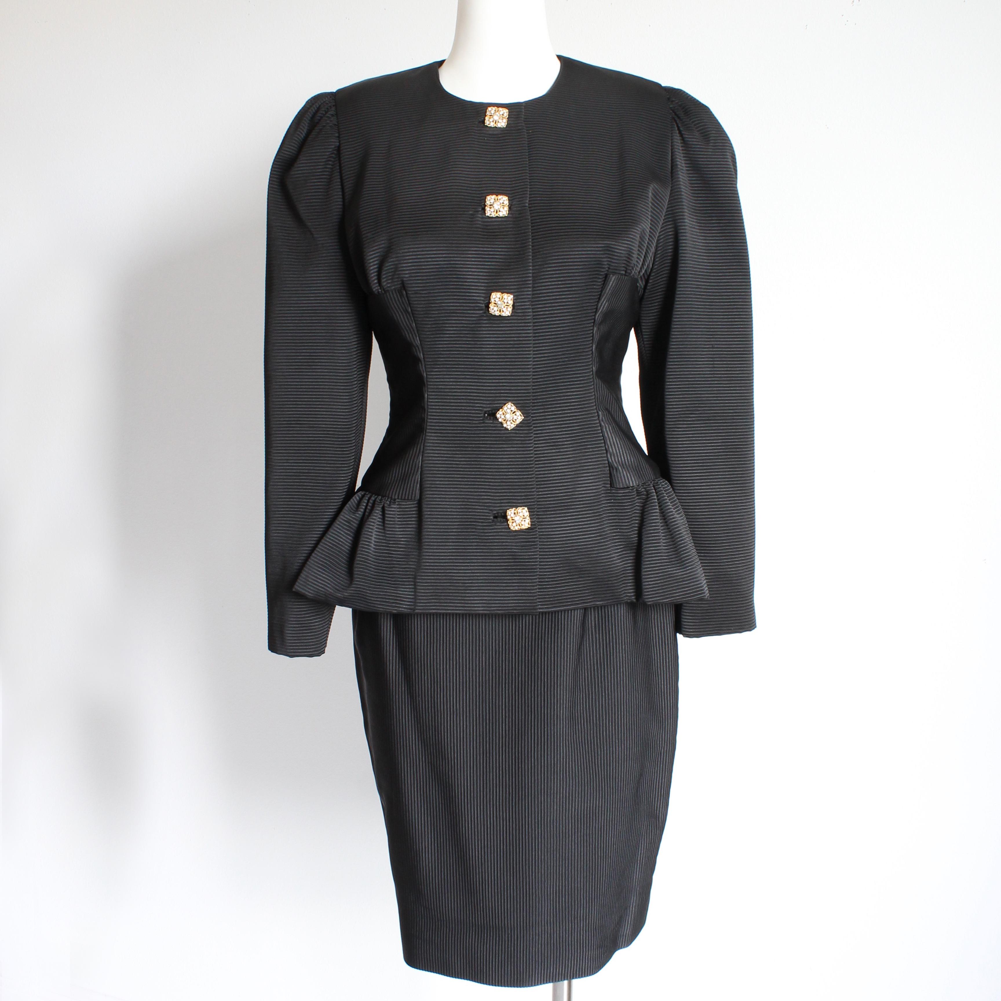 Authentic, preowned, vintage 2pc Jacket and Skirt suit by Kevan Hall Couture, likely made in the early 90s. Made from a pintuck black rayon fabric, the jacket has a fitted waist with peplum, and fastens with rhinestone encrusted buttons. The
