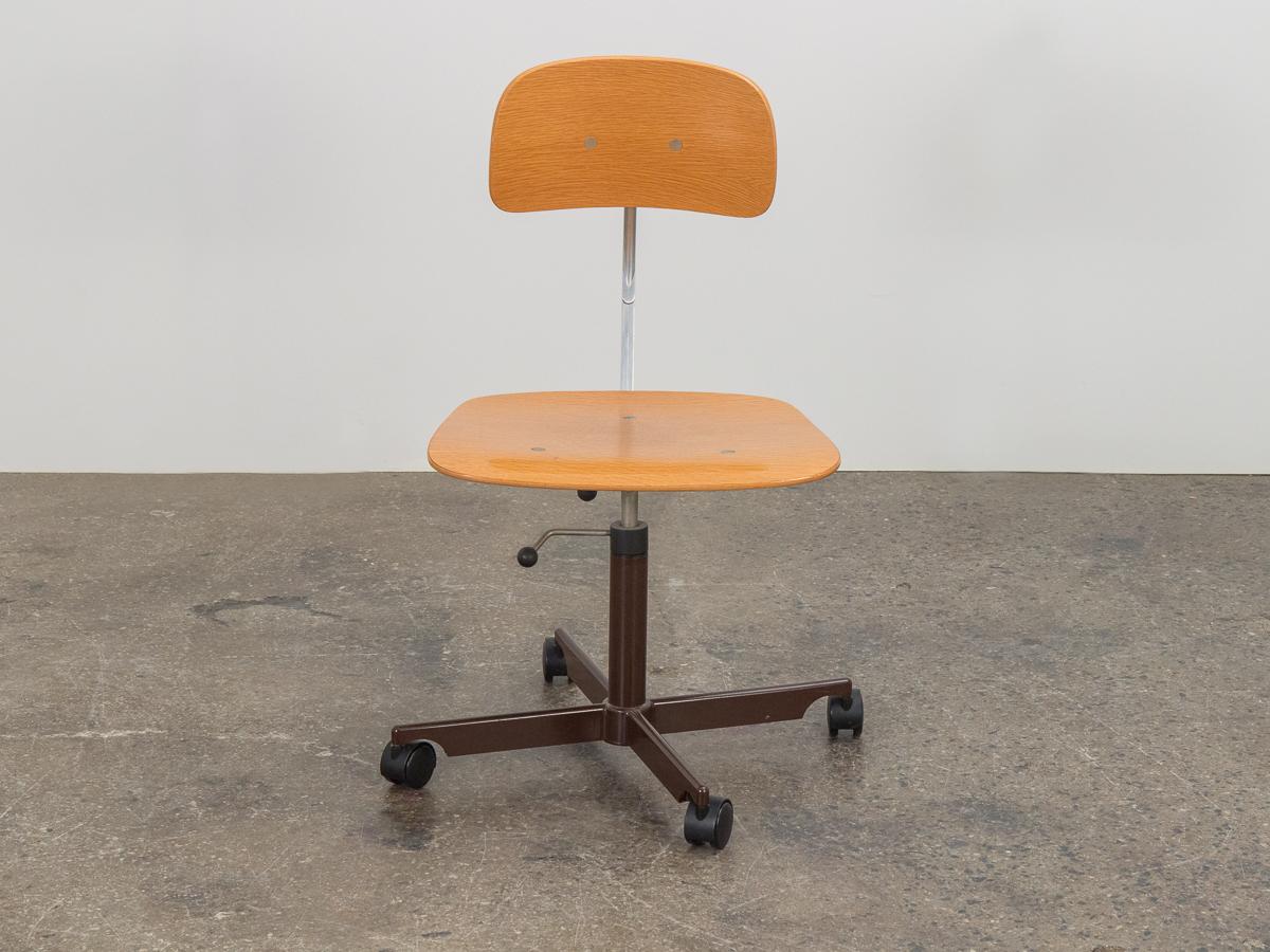 Kevi Swivel desk chair designed by Jorgen Rasmussen. A perfect office chair. Seat and back are constructed of blonde oak, with nice grain and clean edges throughout. Seat height is adjustable, and seat back leans naturally with the direction of the