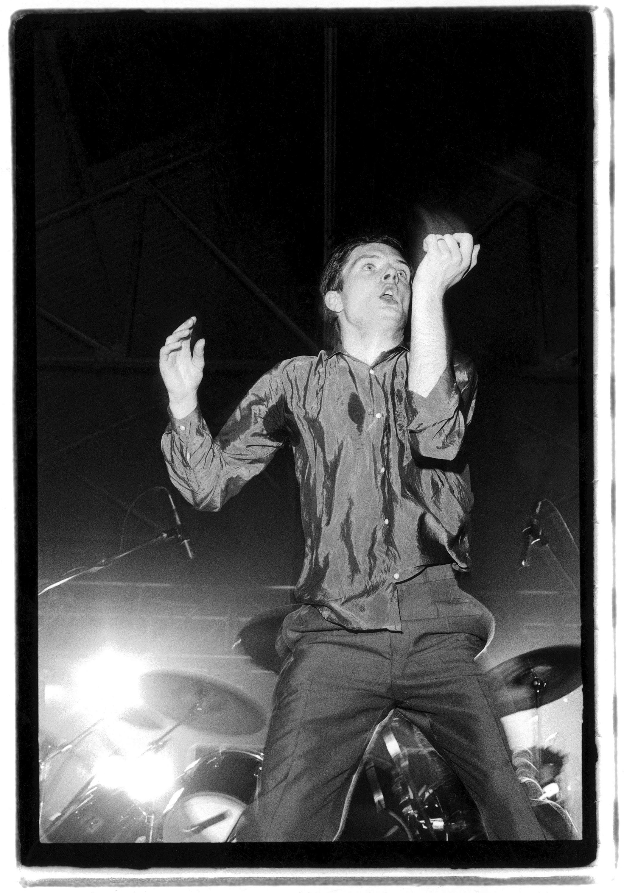 Signed limited edition silver gelatin print of British singer Ian Curtis performing with Joy Division at the Futurama One Festival at the Queen's Hall, Leeds, 8th September 1979. The event was billed as 'The World's First Science Fiction Music