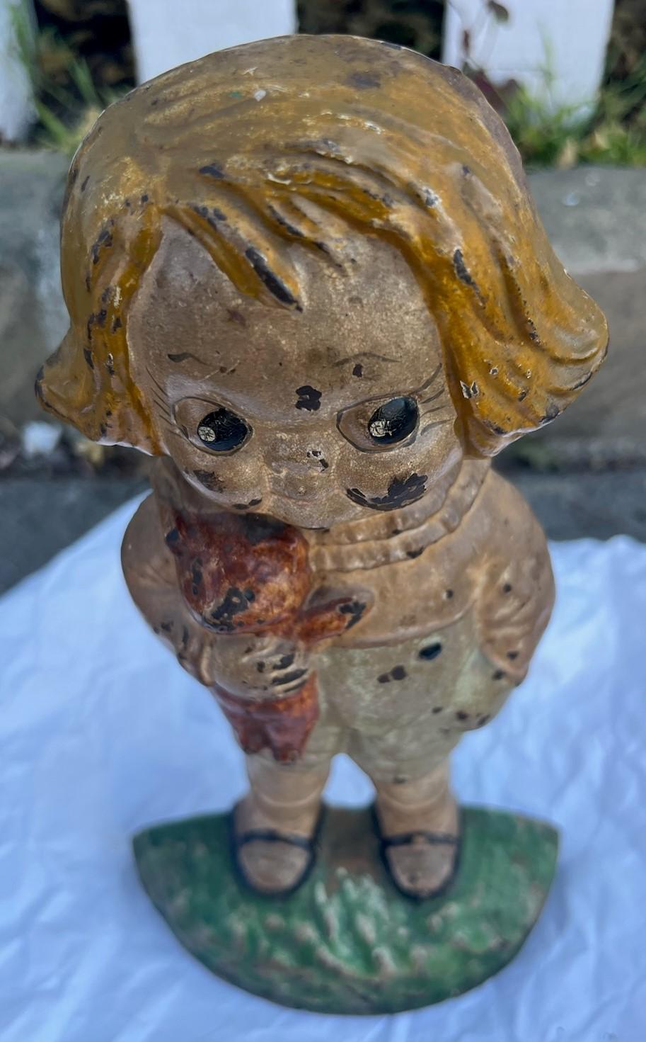 This fun and folky Kewpie girl cast iron doorstop is quite rare and in original painted surface.Notice she is holding a teddy bear.So amazing to find one like this in undisturbed surface.